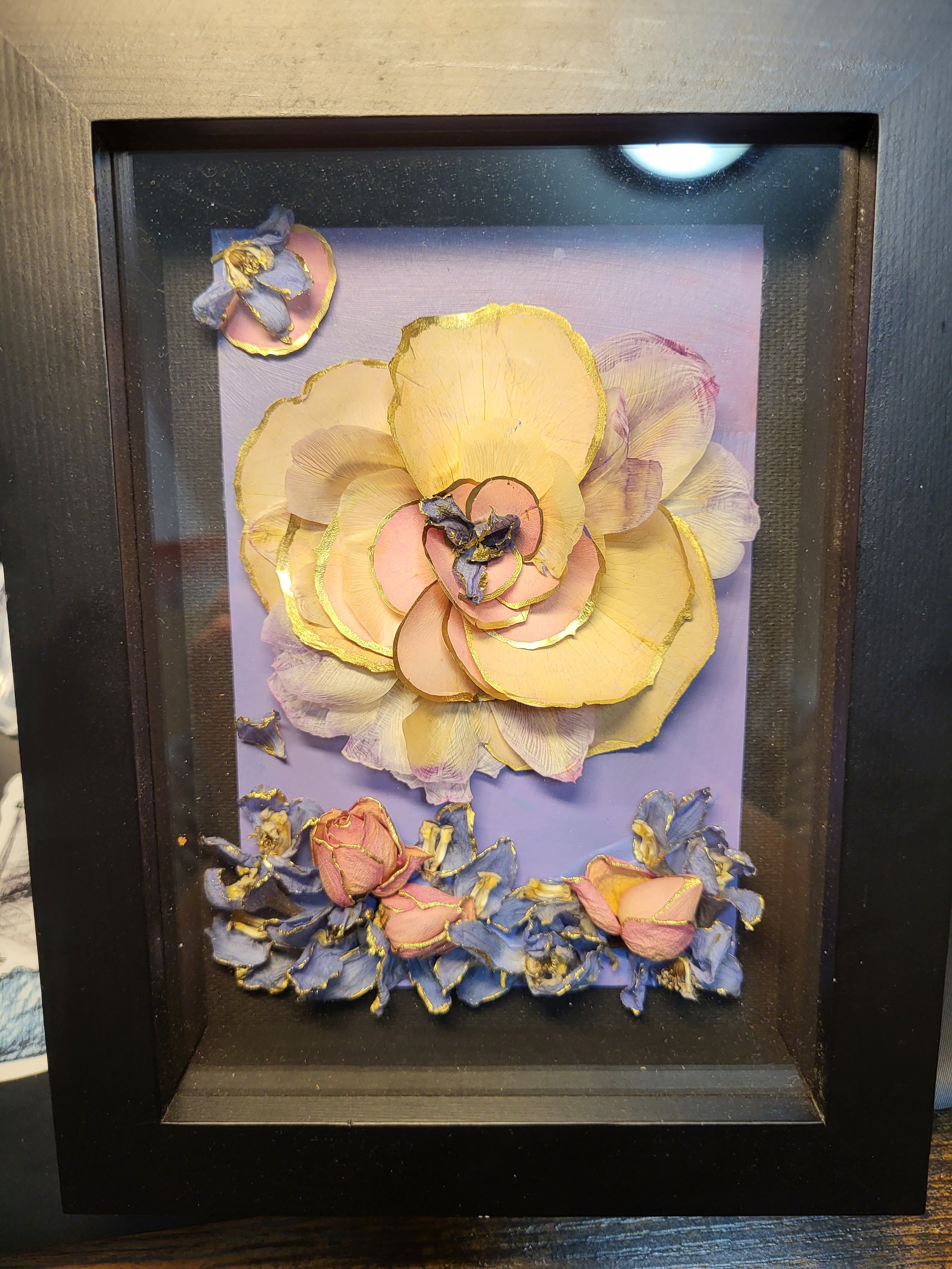 acrylic painting decorated with flowers and framed in shadow box