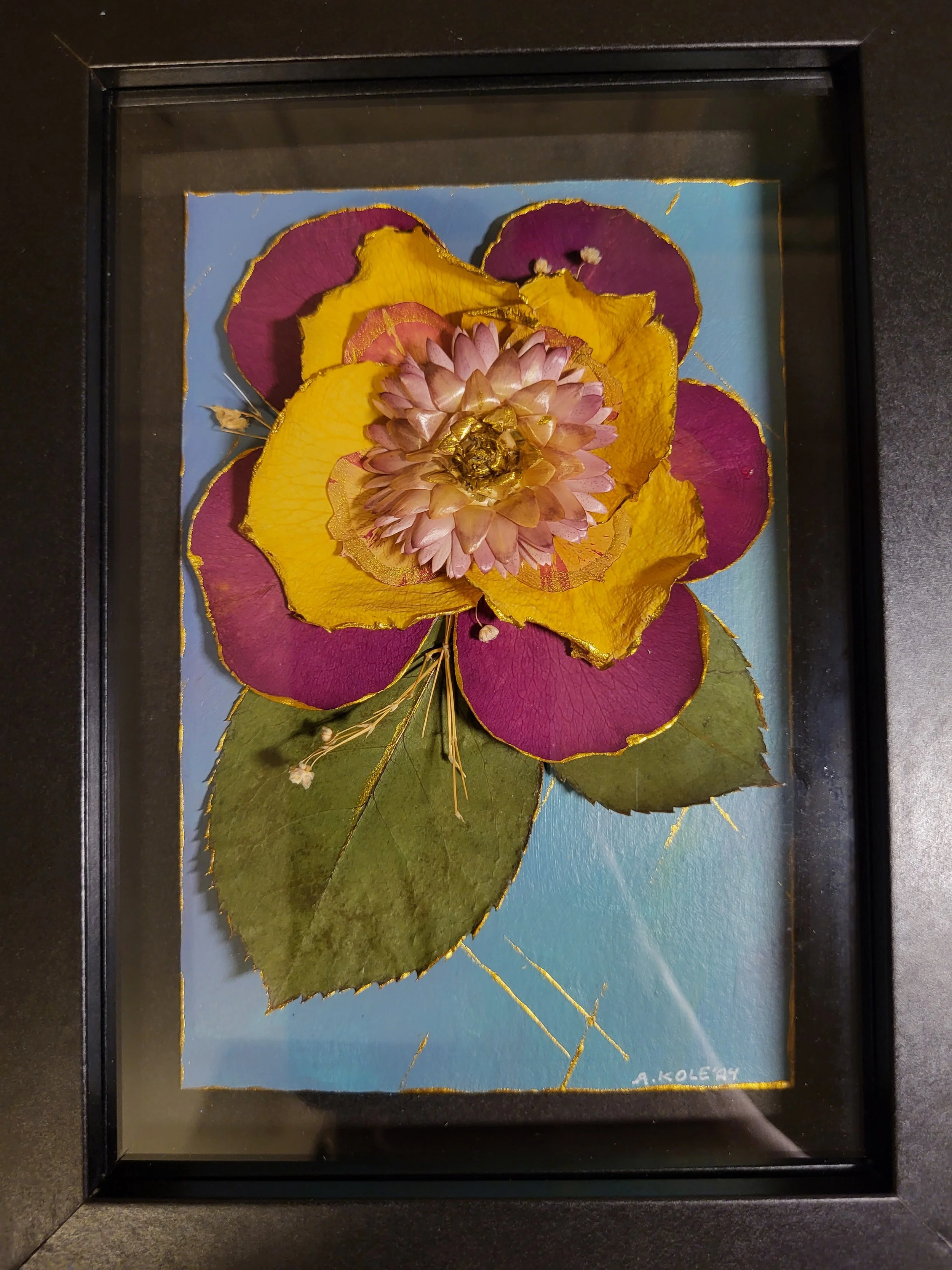acrylic painting decorated with flowers and framed in a shadow box