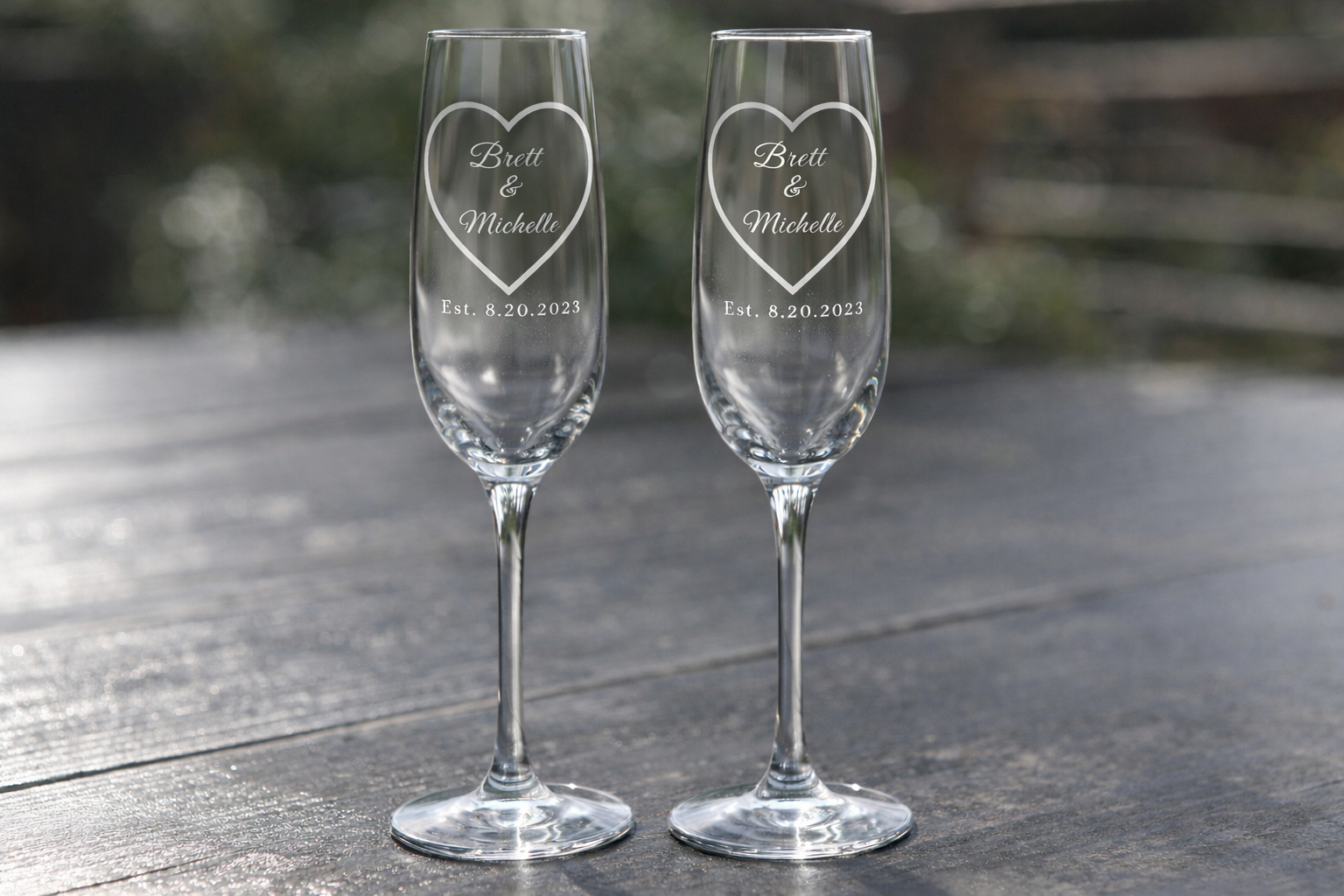 Personalized champagne flutes, stemless wine, and rocks glass with heart design, names and established wedding date engraving