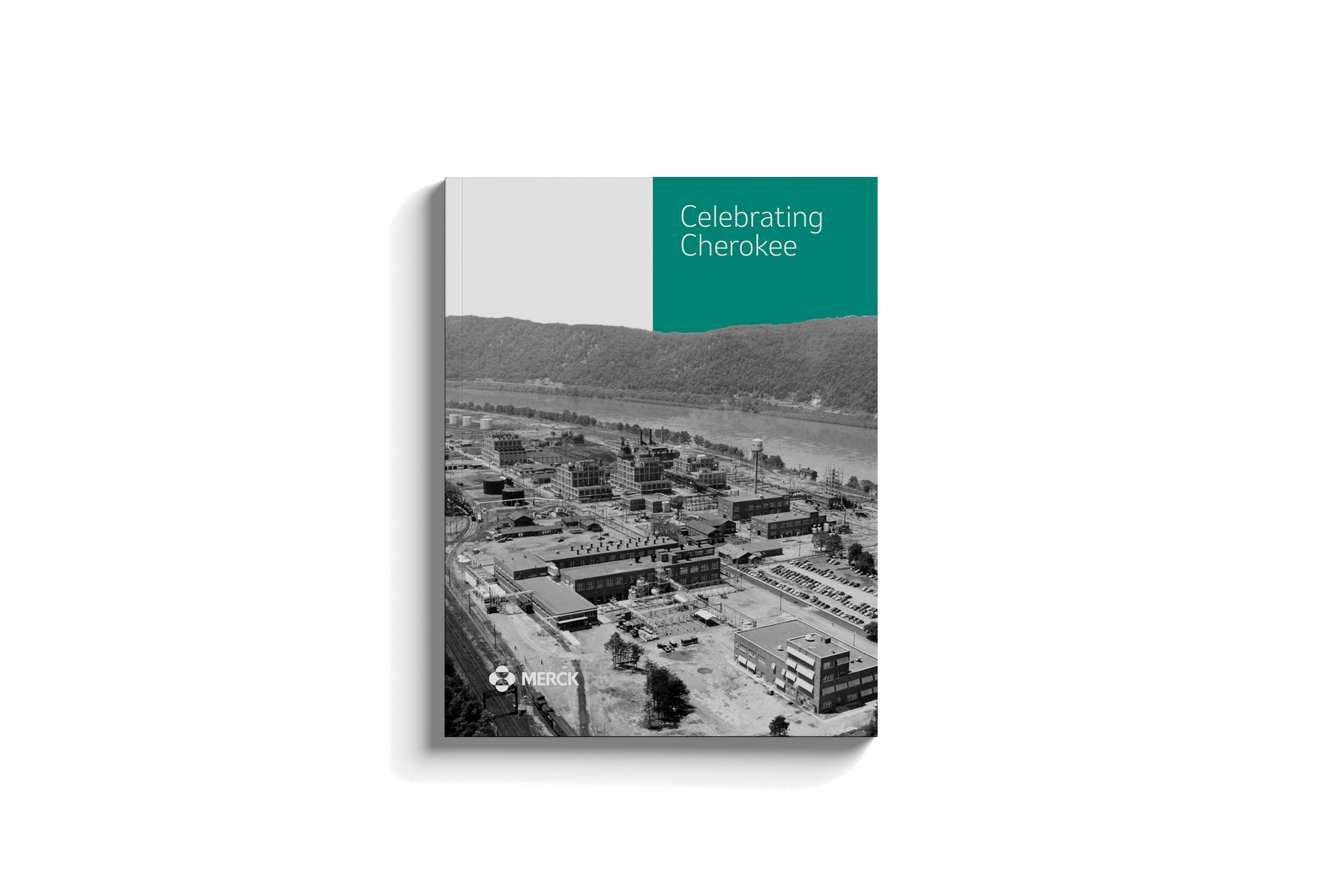 Book titled 'Celebrating Cherokee' with a black and white aerial photograph of a small town or industrial area, with a river and hills in the background, and a Merck logo at the bottom.