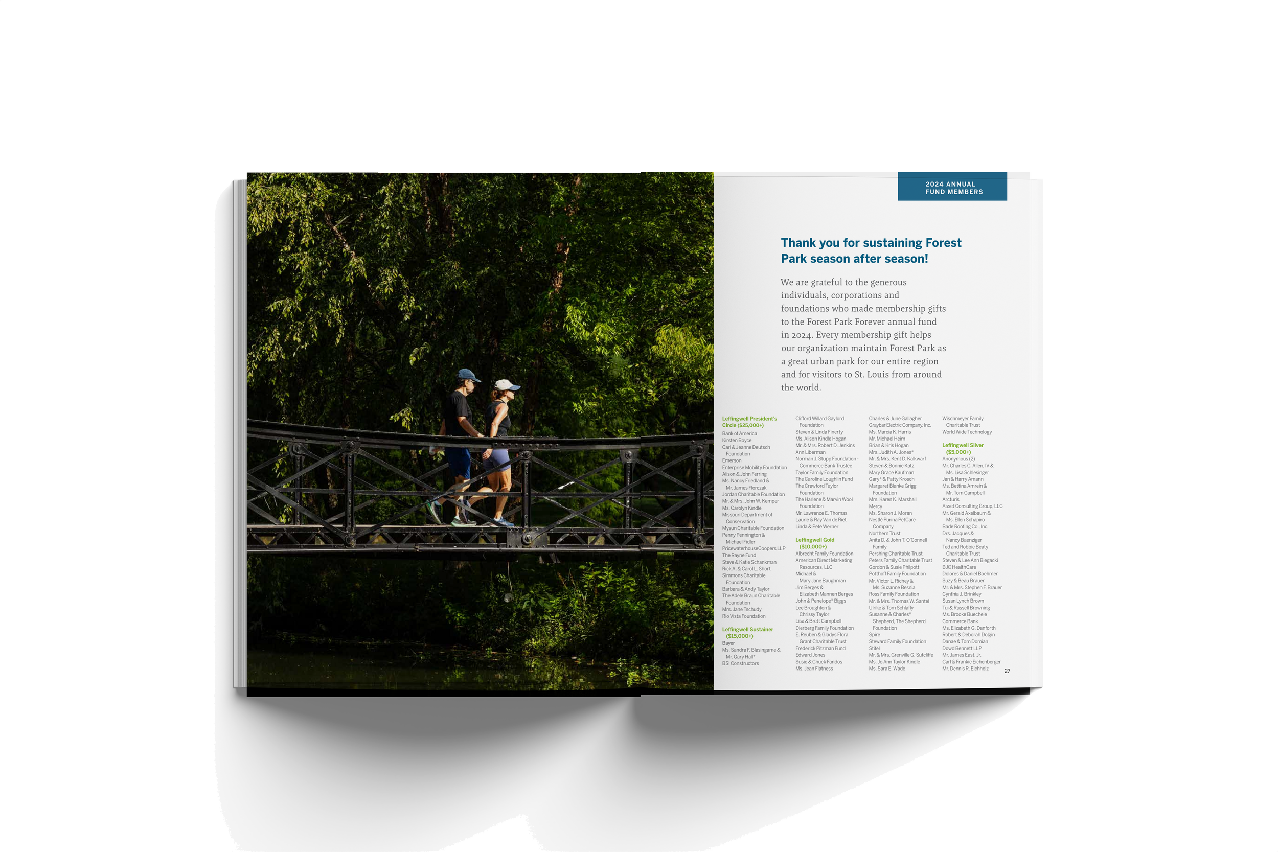Open magazine showing a photo of two people walking on a bridge over water, surrounded by green trees, and a page with text thanking donors for supporting Forest Park.