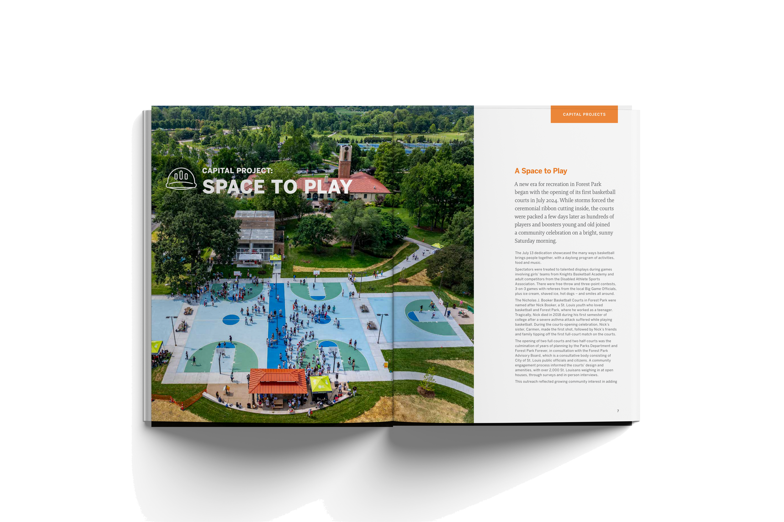 Open magazine showing aerial view of a community basketball court with people playing, a building with a red roof, and surrounding green park and trees, with text about a new recreation space.
