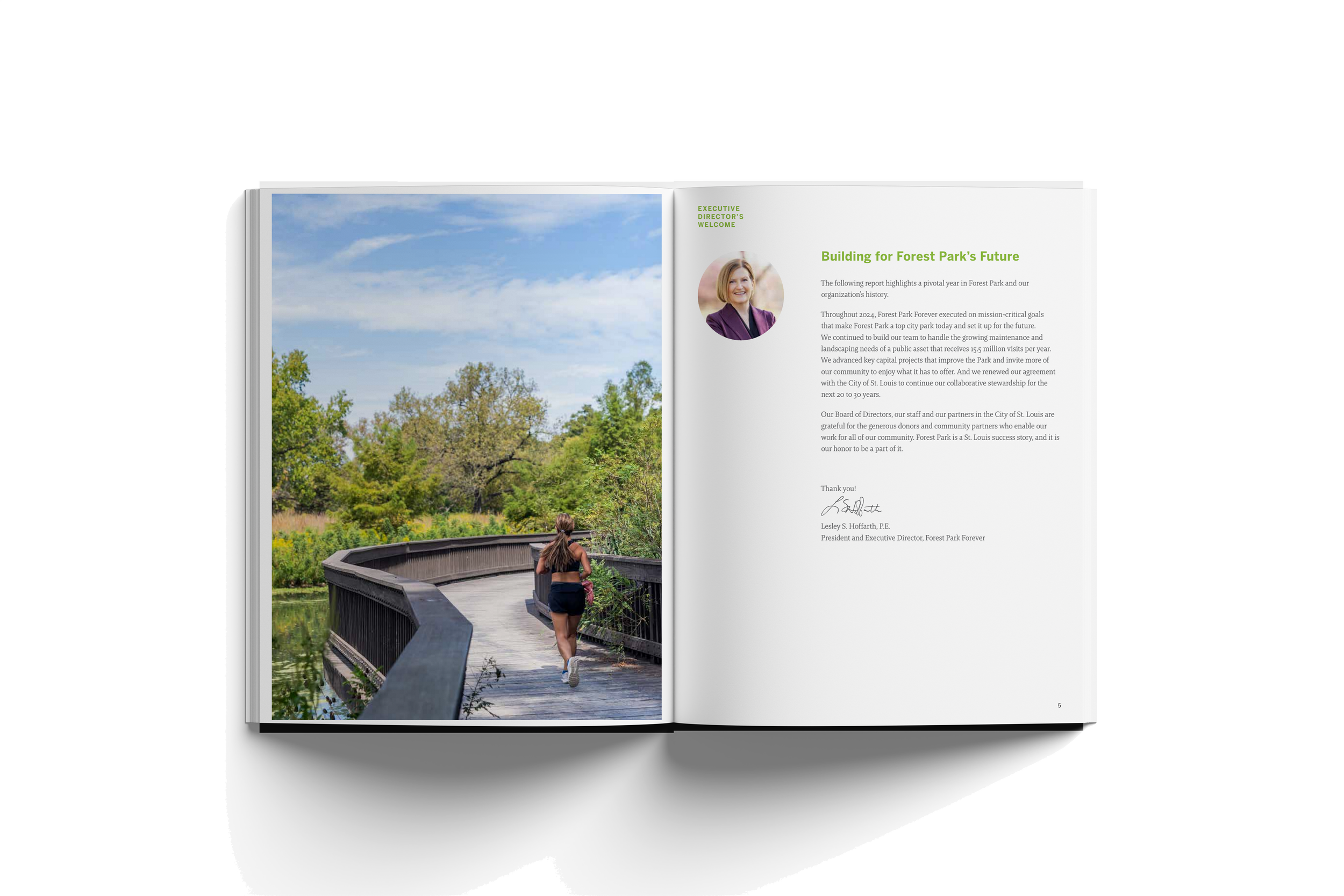 Open magazine showing a left page with a photograph of a woman jogging on a wooden bridge surrounded by greenery and blue sky, and a right page with text about Forest Park's future, a small circular portrait of a woman, and a signature.