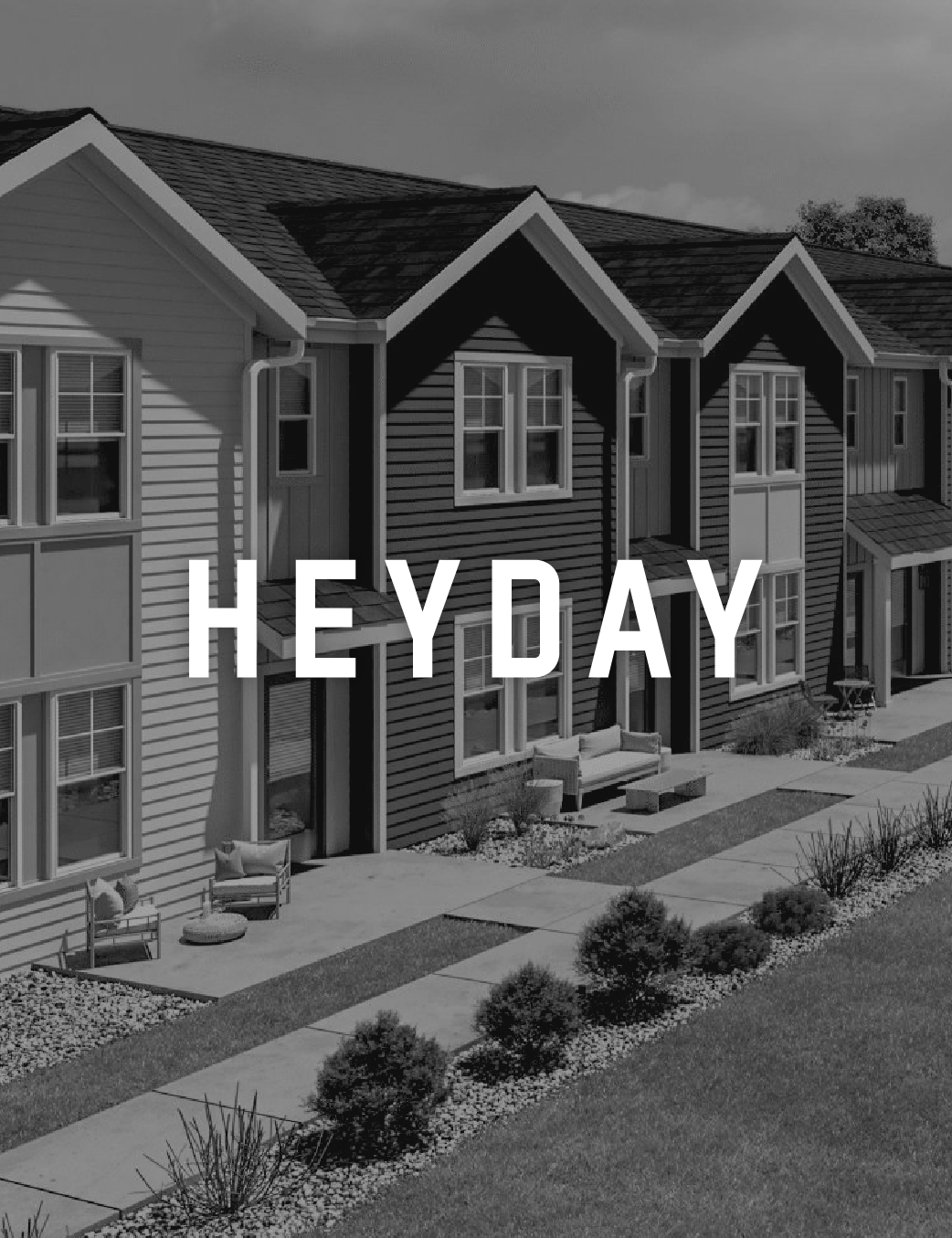 A row of modern townhouses with front porches, windows, and landscaped yards, with the text 'HEY DAY' written across.
