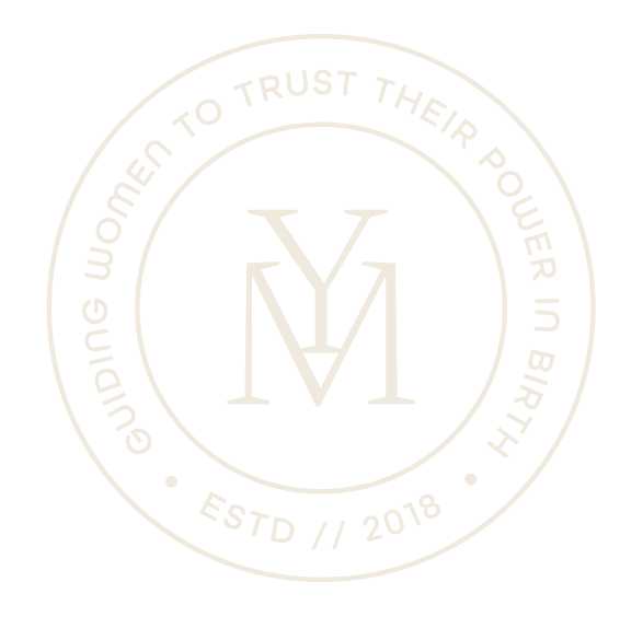 Black circular logo with white text reading "Guiding women to trust their power in birth," with a stylized monogram "YM" in the center, and the establishment year 2018 at the bottom.
