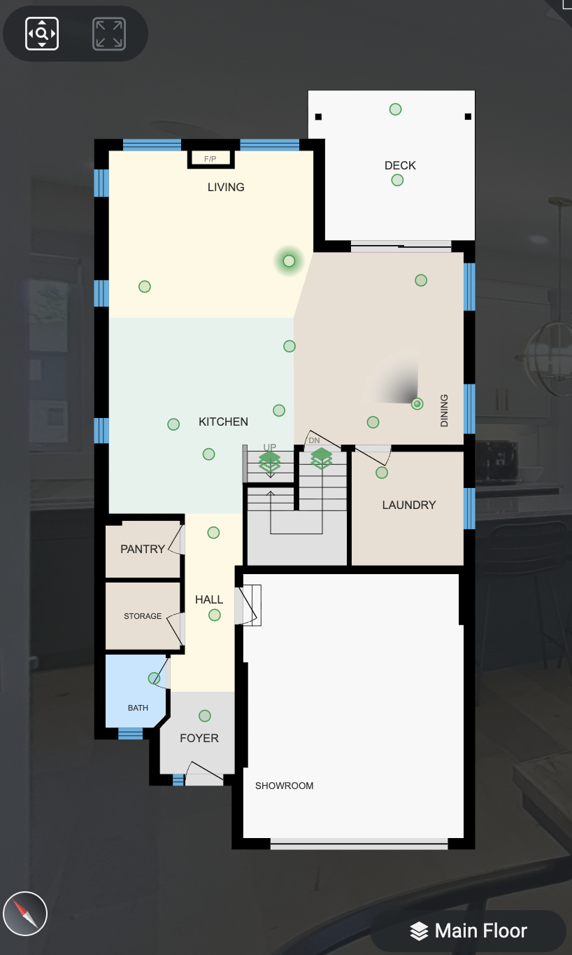 Real Estate Niagara Homes - IGuide - Floor plan of a house's main floor showing various rooms including foyer, bath, storage, pantry, kitchen, living room, dining room, laundry room, and a showroom connected to a deck outside.