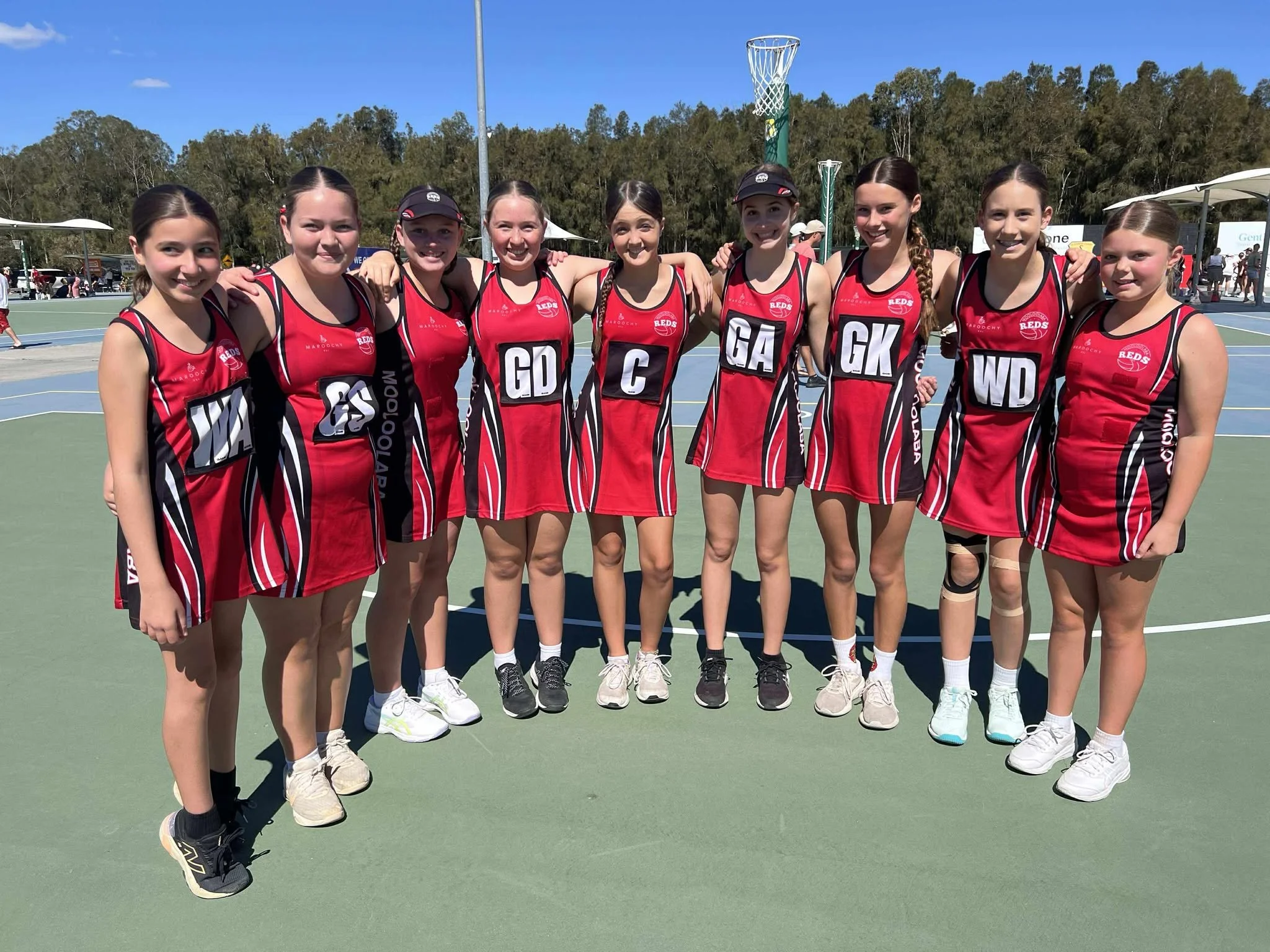 Mooloolaba Reds team at Fishermans Road Netball smiling at camera