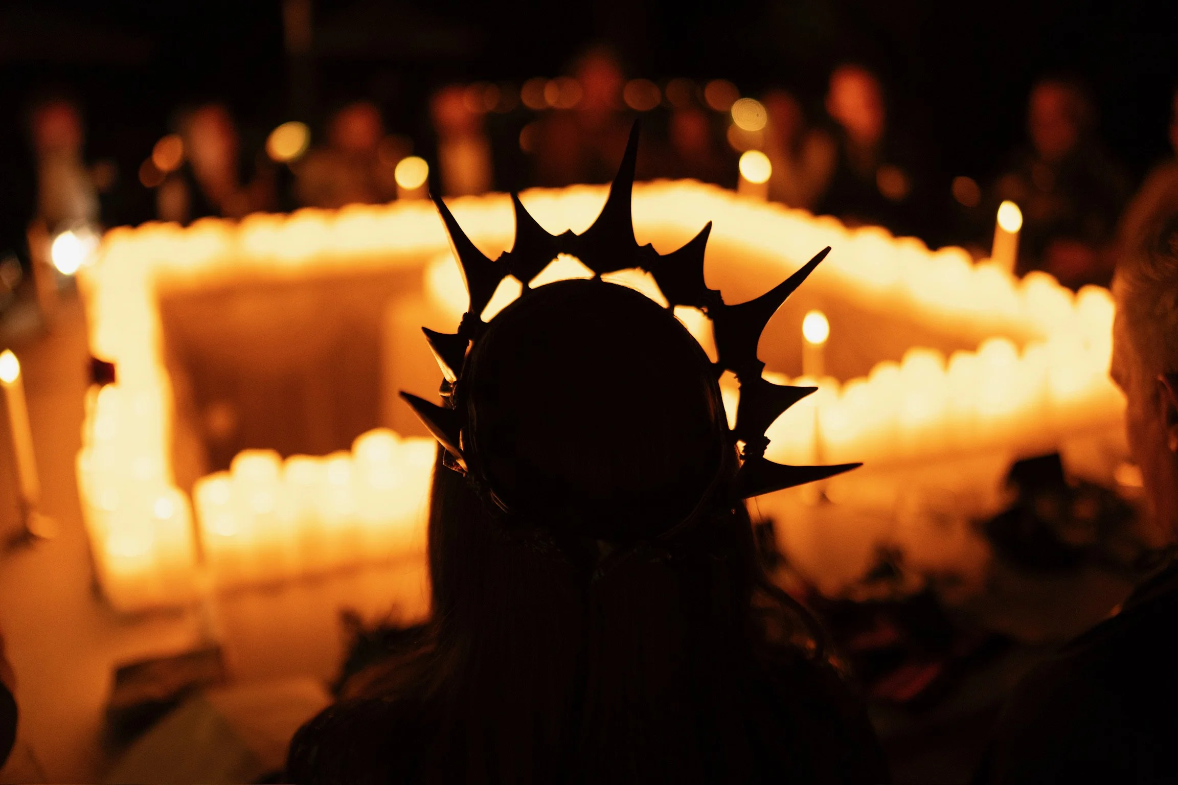 A cinematic moment from a Curtain Call experience, featuring candlelit rituals, immersive storytelling, and strategic gameplay inside a living world of mystery and intrigue.