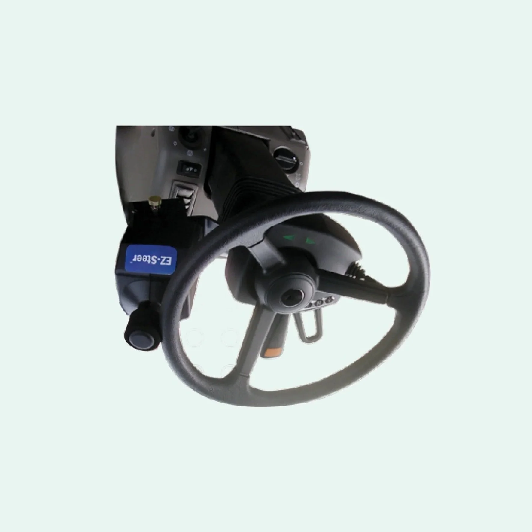 A medical digital device connected to a steering wheel with green arrow buttons.