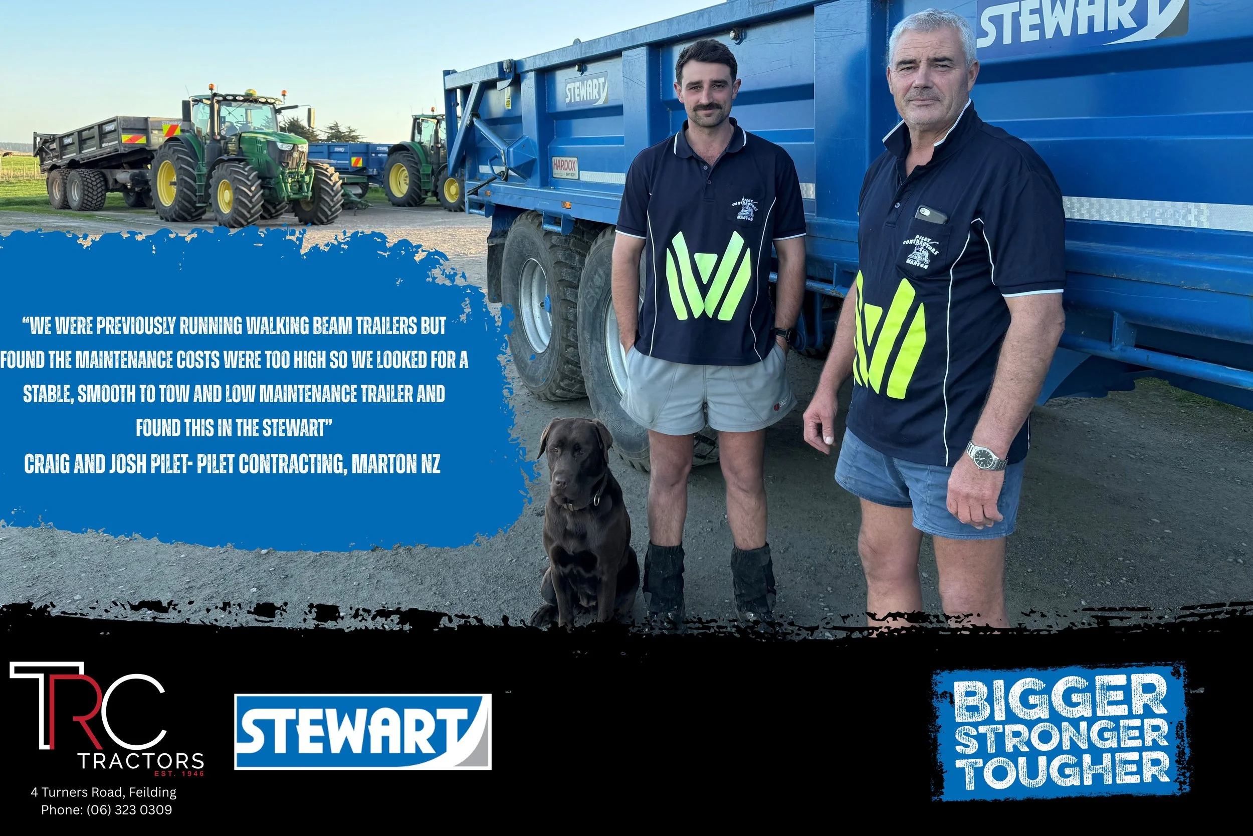Two men standing outdoors in front of a large blue Stewart trailer, with tractors and open land in the background. One man has short gray hair and is wearing a dark shirt, the other has dark hair and a mustache, wearing a sports jersey. There is a do