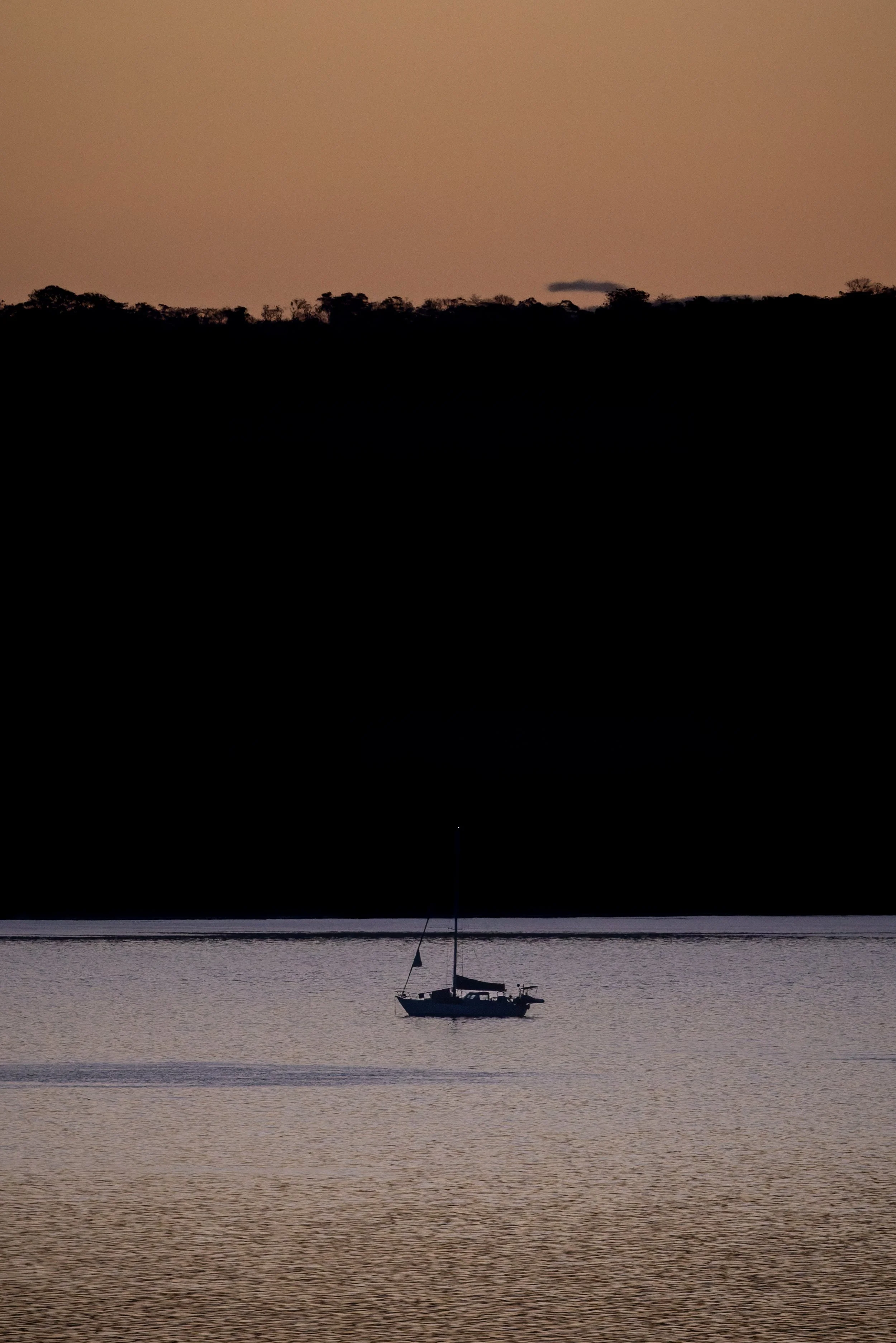 Boat on calm water at sunrise, Papagayo Peninsula, Costa Rica
