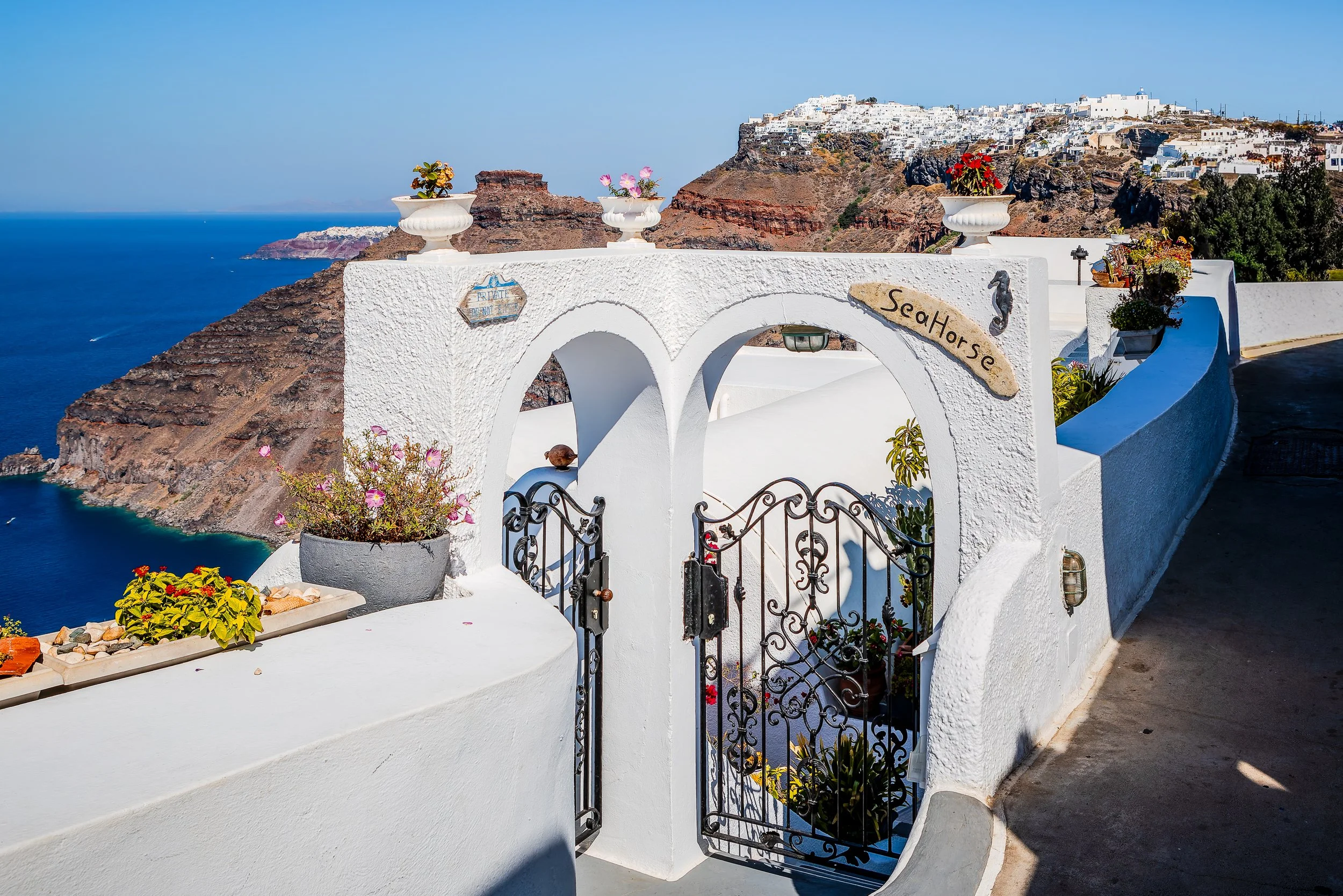 White archway overlooking Santorini caldera, Fira, Greece