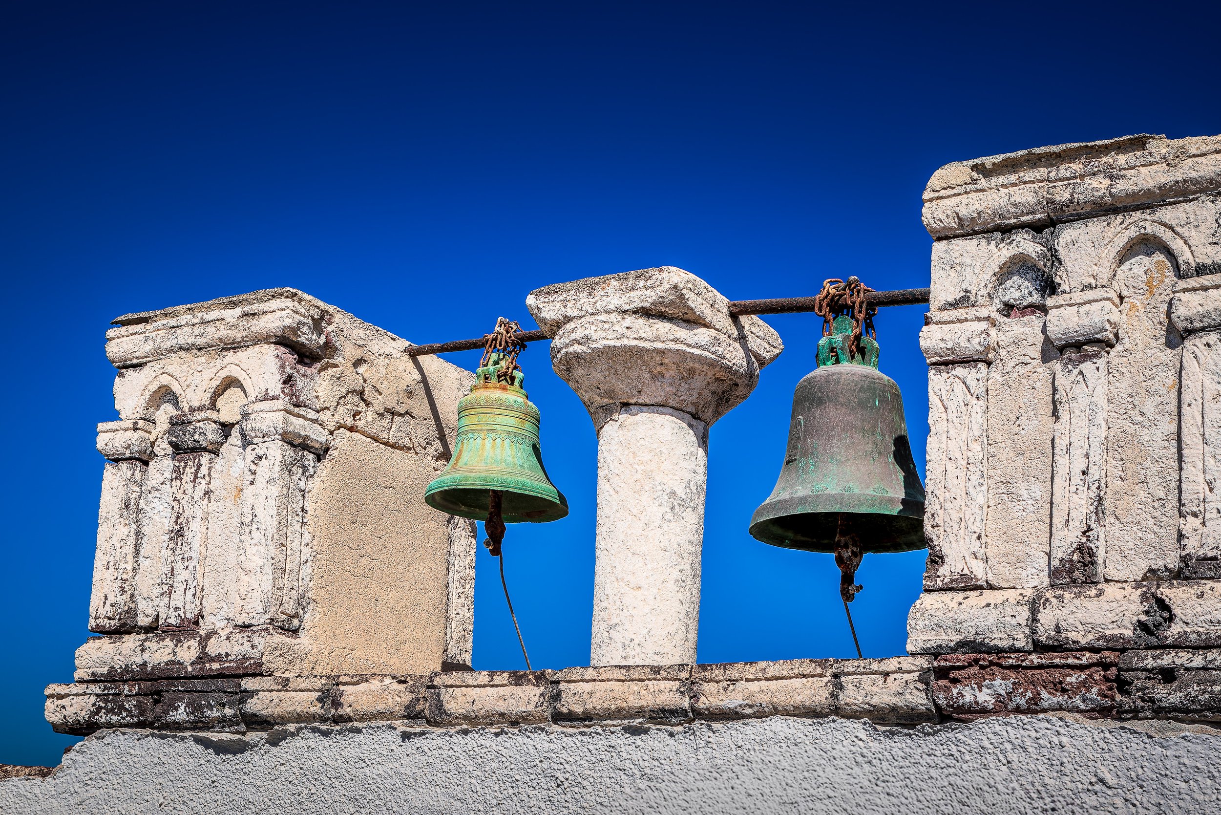 Church bells and stone arch in Oia, Santorini, Greece