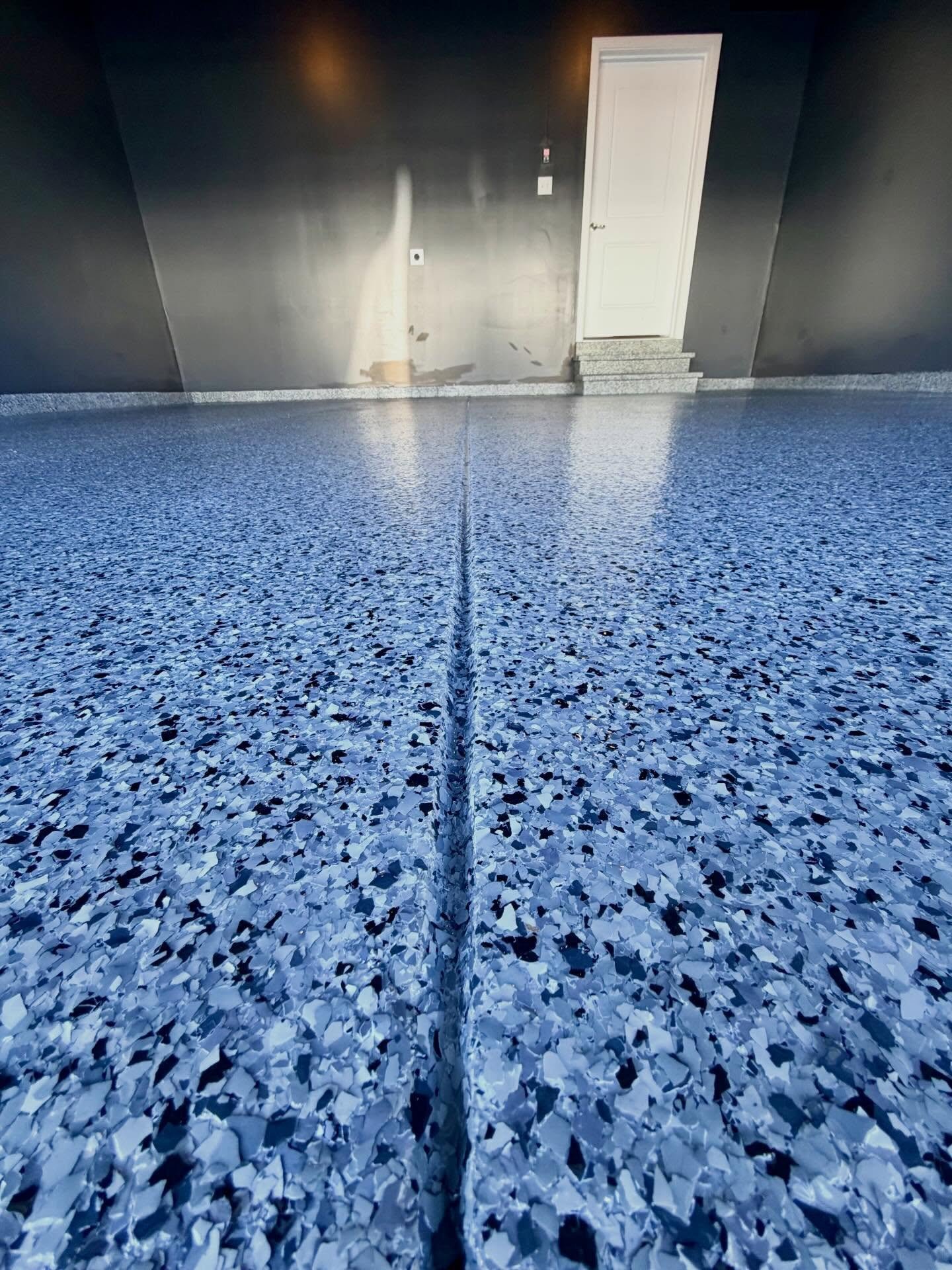 Nightfall flakes in #easthanovernj really@made this garage stand out. Our #simiron polyaspartic flake system is durable, sleek, and UV-stable. Transform your space today! Contact us for your free estimate!