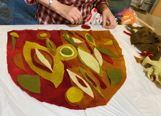 Person laying out a felting design