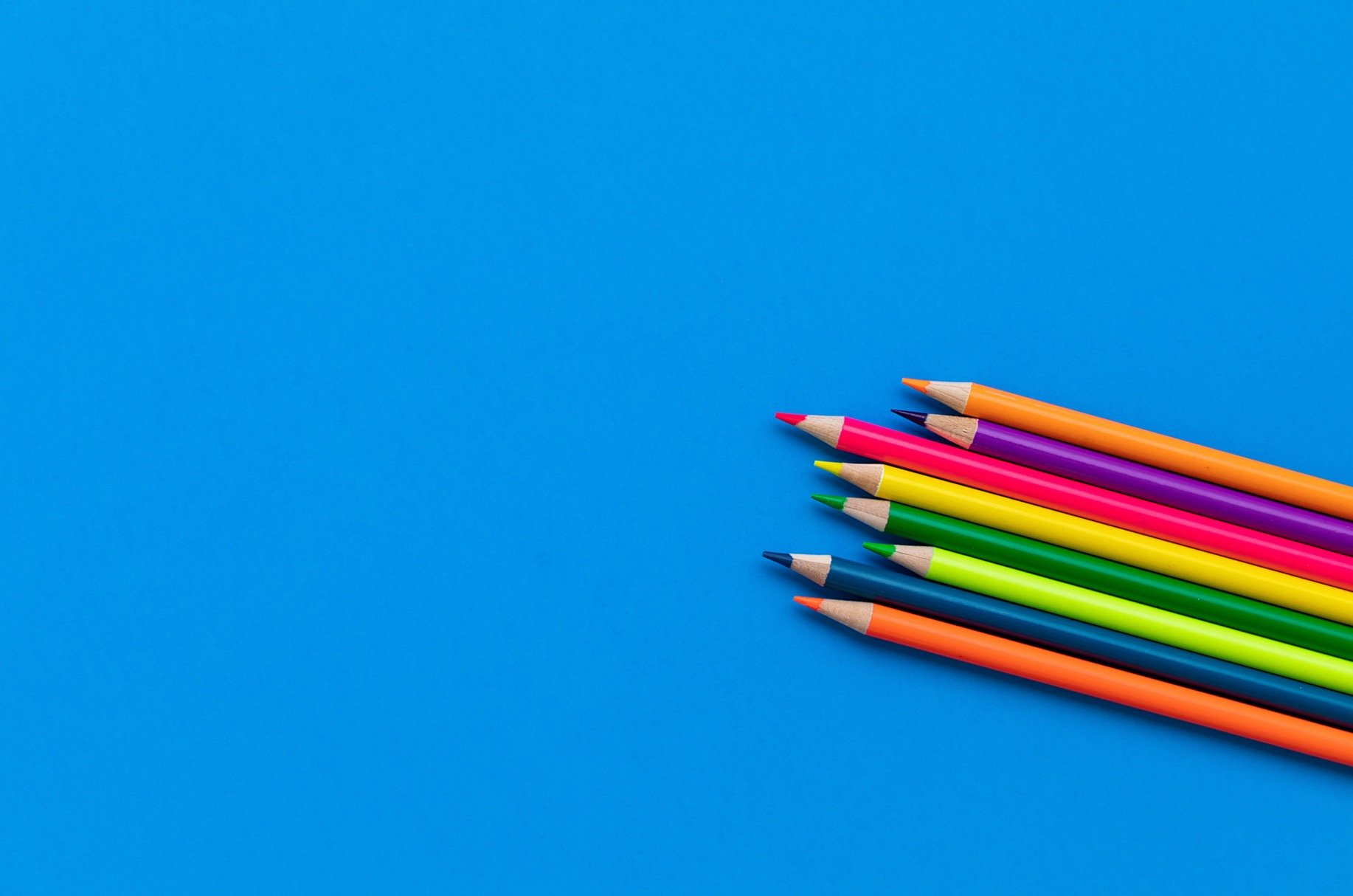 colored pencils on a blue background