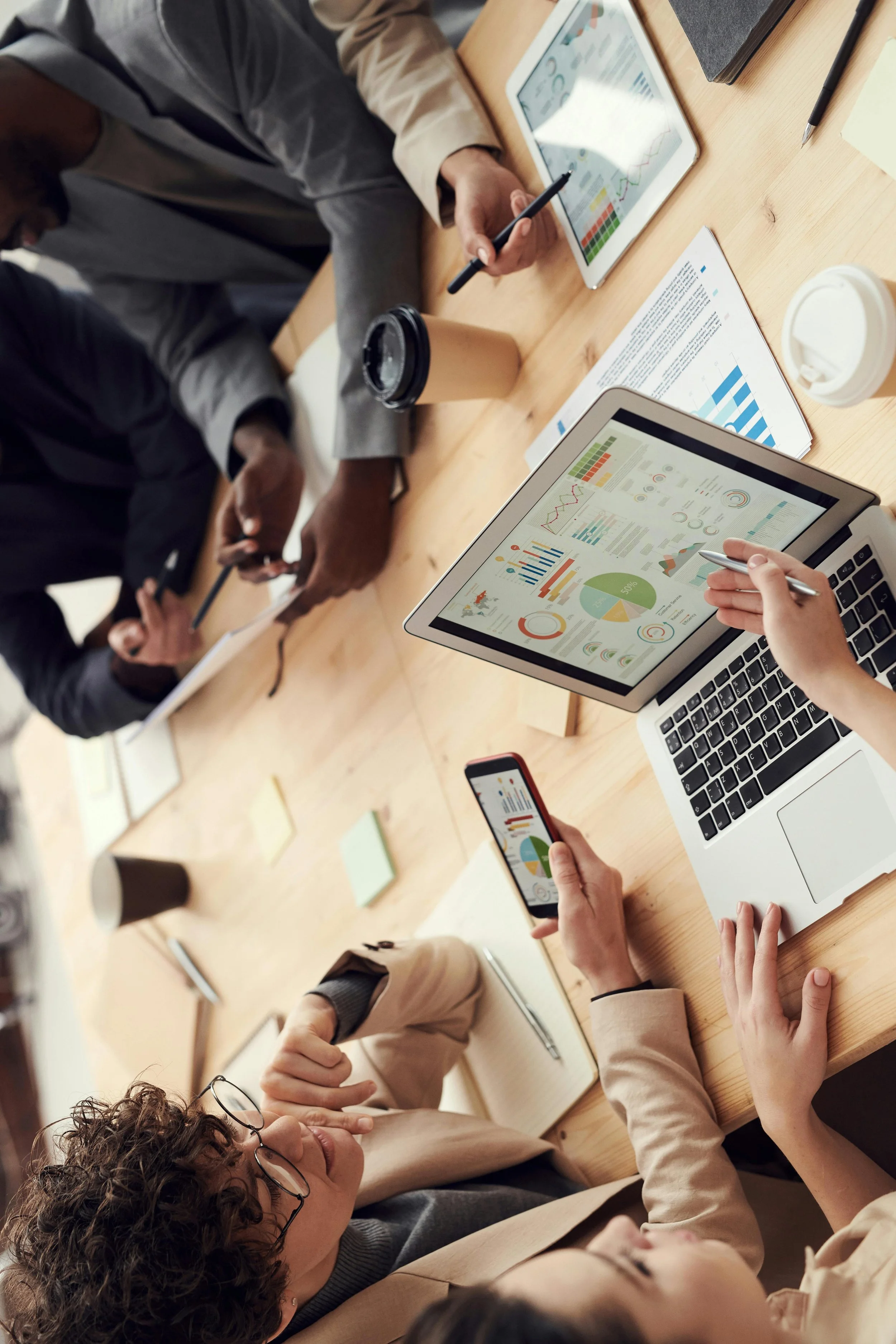 people discussing charts near a table