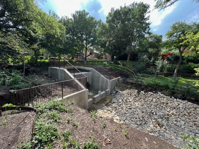 Professional metal fencing and railing installation for retaining walls and drainage systems, designed for safety, durability, and code compliance. This project features custom-fabricated steel safety railings installed along concrete retaining walls