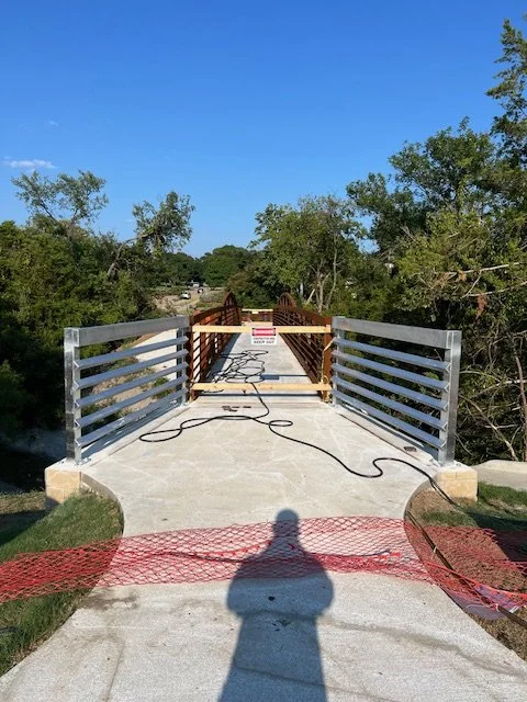 Custom galvanized steel guardrail installation in Dallas–Fort Worth, TX, designed for pedestrian bridge safety and long-term durability. This project features heavy-duty galvanized metal railings fabricated and installed along a concrete walkway lead
