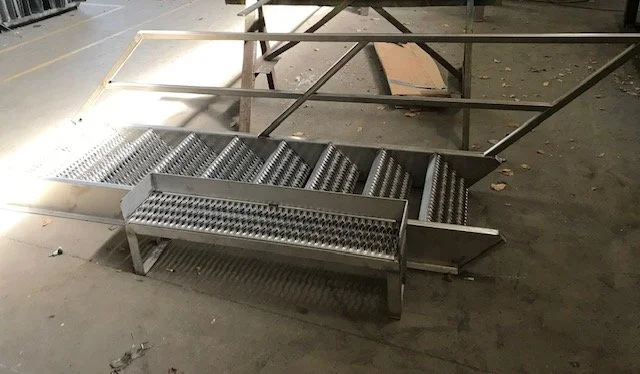 Custom stainless steel roller conveyor fabrication in Dallas–Fort Worth, TX, designed for high-efficiency material handling in industrial and production environments. This heavy-duty conveyor system features precision-aligned rollers and a durable st