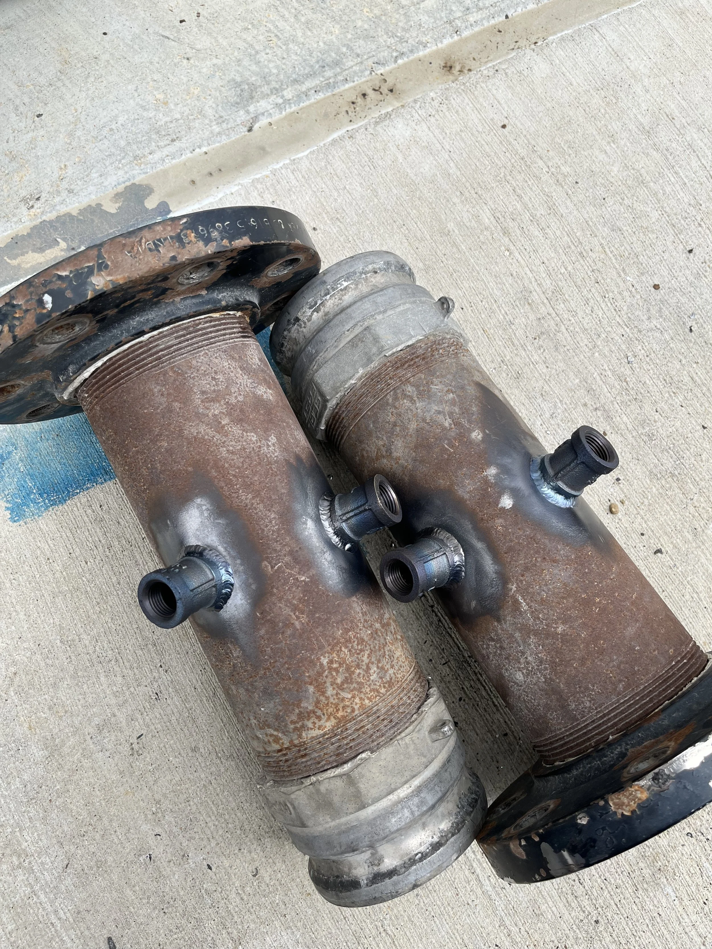"Professional custom fabrication and welding for vacuum truck manifolds, serving the DFW metroplex. Heavy-duty steel pipe repair with precision-welded threaded ports for industrial pump systems."