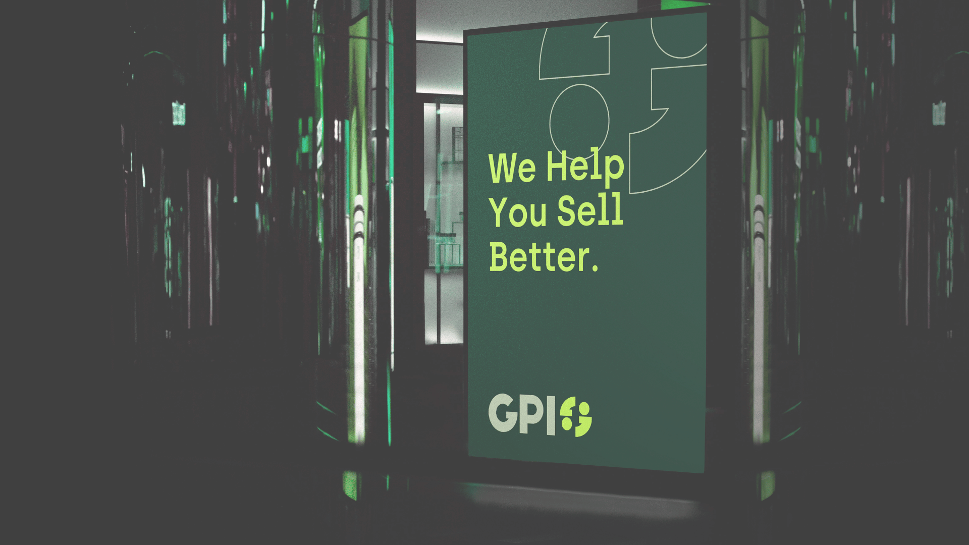 A large vertical sign with the text 'We Help You Sell Better.' and the logo 'GPI' displayed at the bottom, situated inside a modern building with reflective surfaces and green lighting accents.
