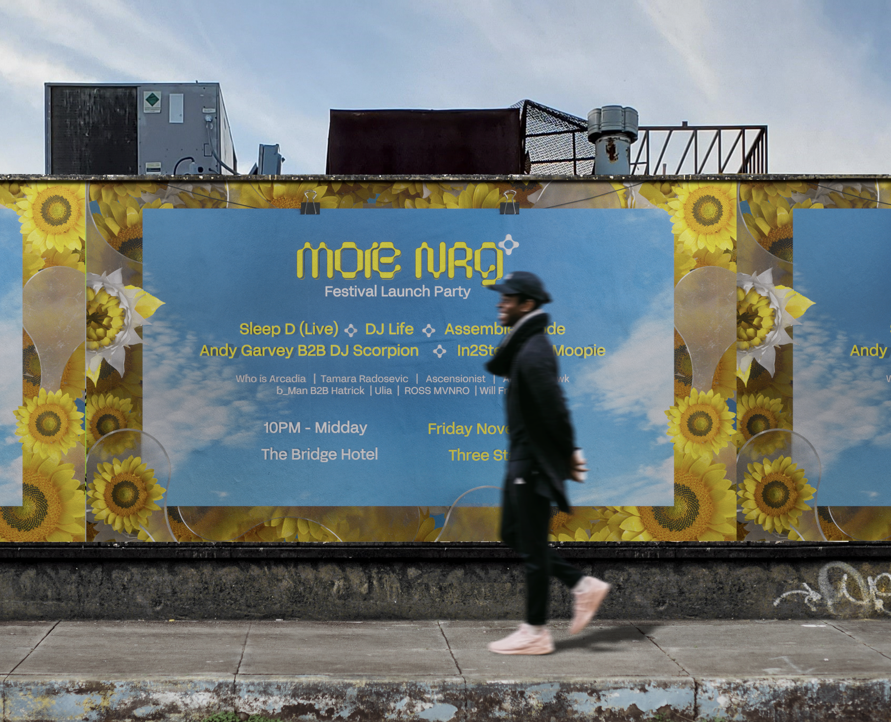 A person walking past an outdoor billboard promoting the MöNRG Festival Launch Party with a sunflower design and event details, against a backdrop of a partly cloudy sky.