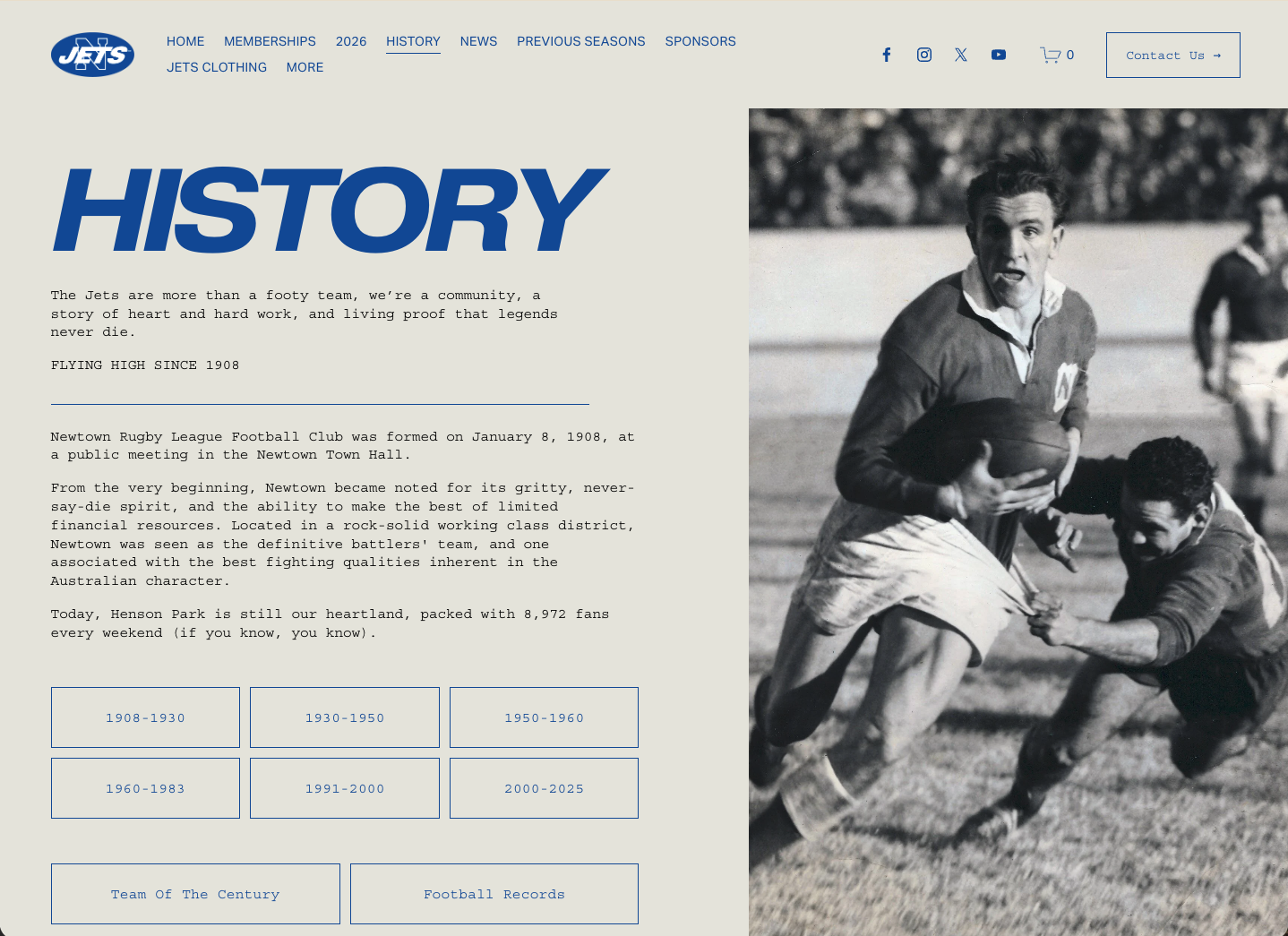 A black and white vintage photo of a football game, with a player holding a football running while an opponent tries to tackle him. Other players are visible in the background.