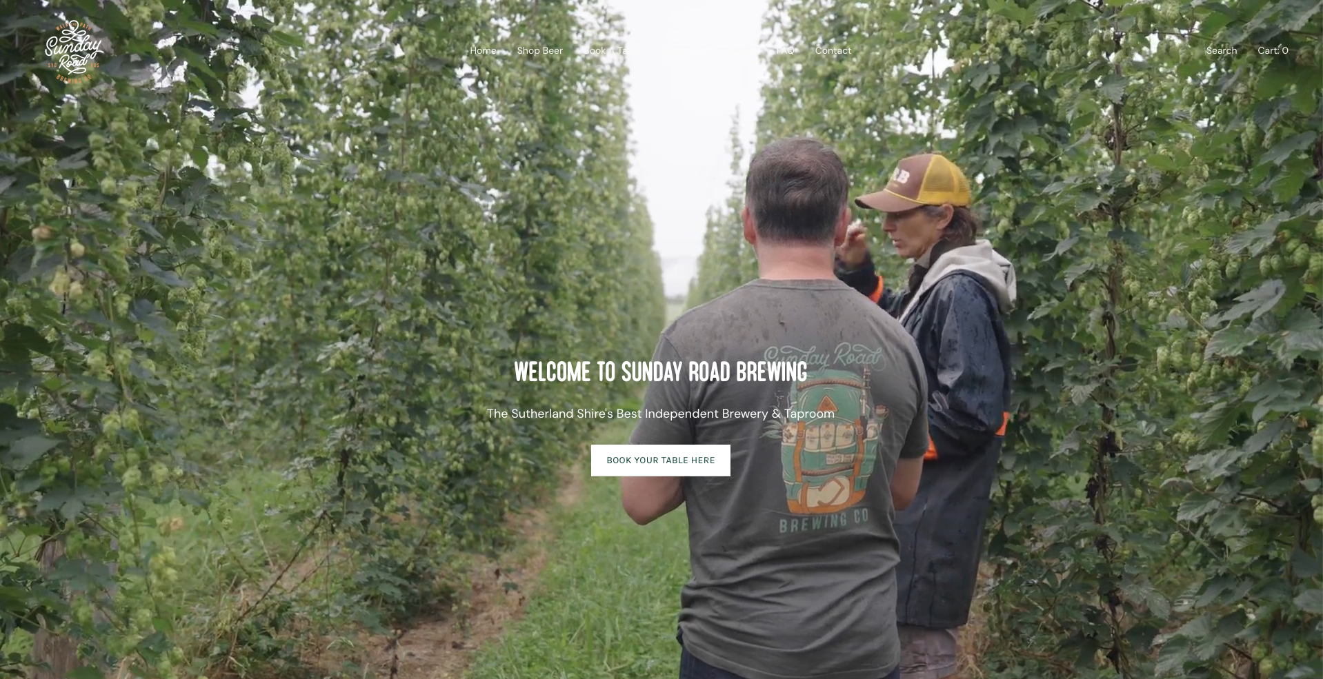 Two men and a woman having a conversation in a hop field at Sunday Road Brewing, an independent brewery and taproom in Sutherland Shire, with green hop plants on either side.