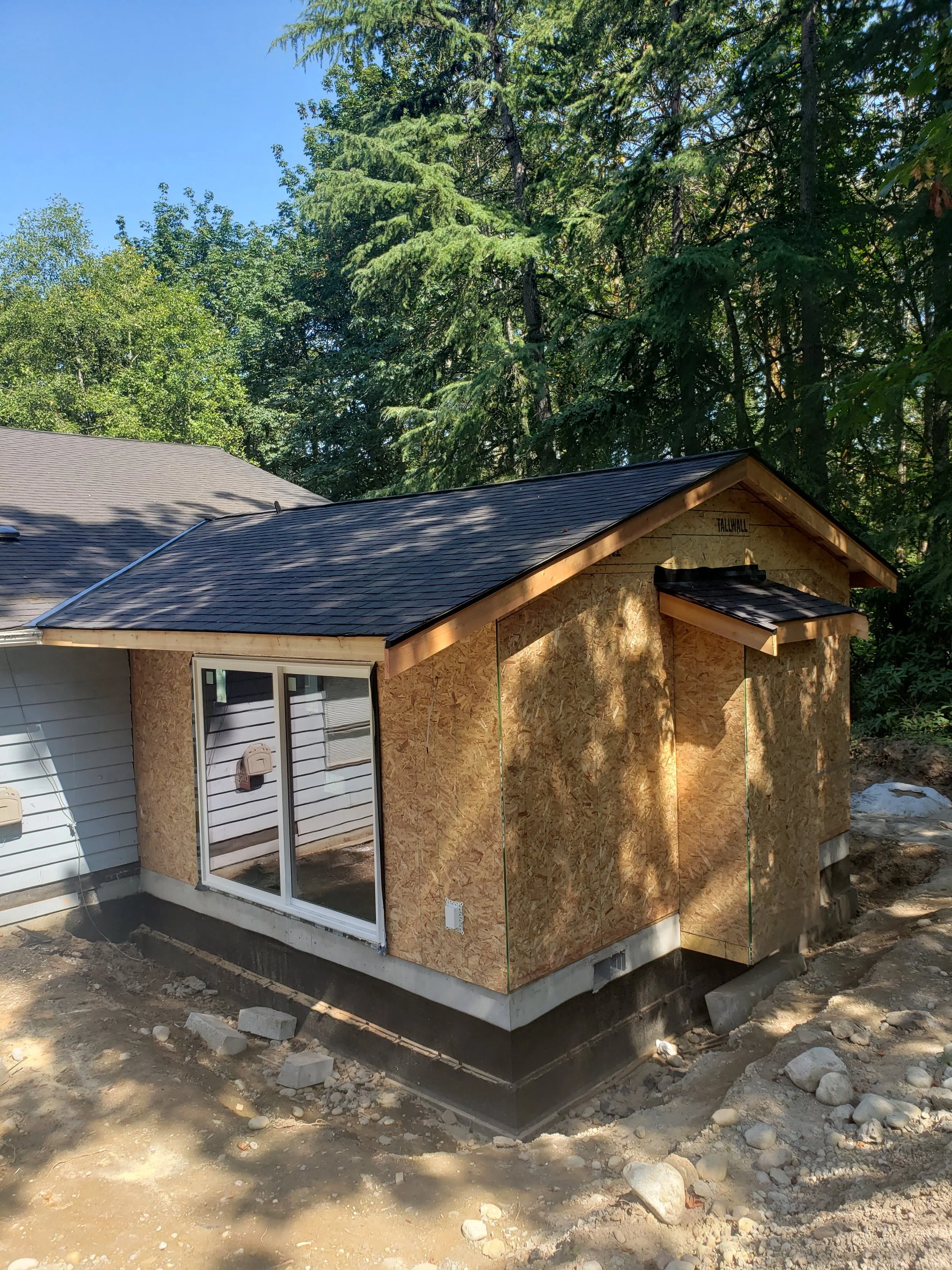 Side view of a house addition under construction.
