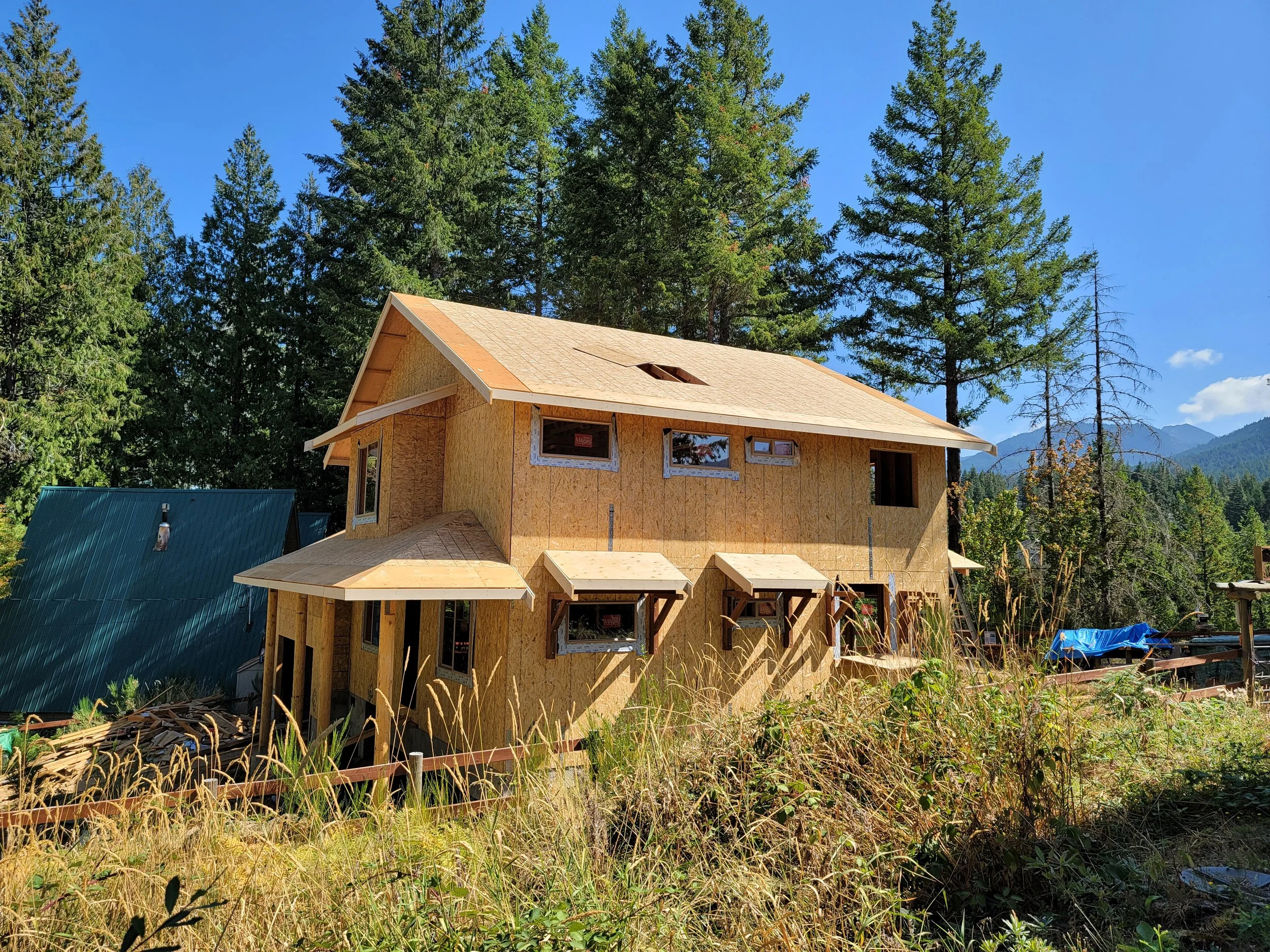 A two-story shell construction house in progress.