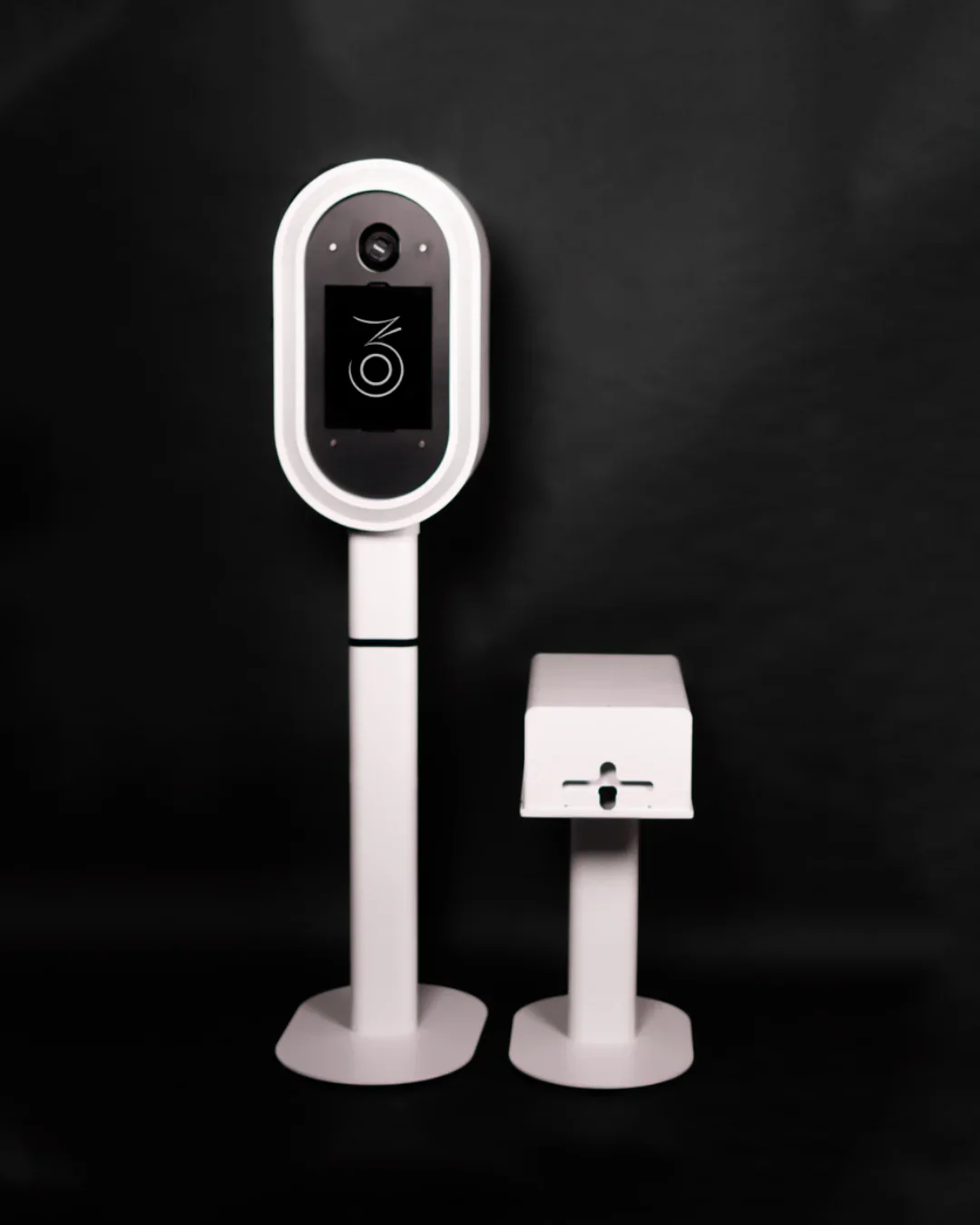 A digital temperature scanner and a hand sanitizer dispenser on a black background.