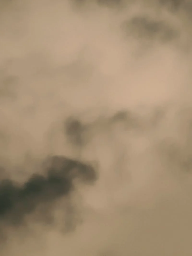 A close-up view of dark smoke clouds in the sky.