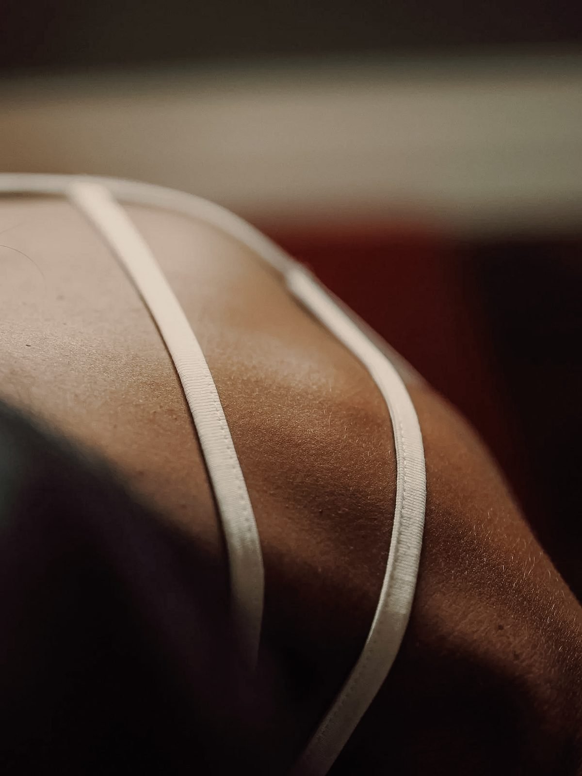 Close-up of brown satin or silk fabric with white piping.