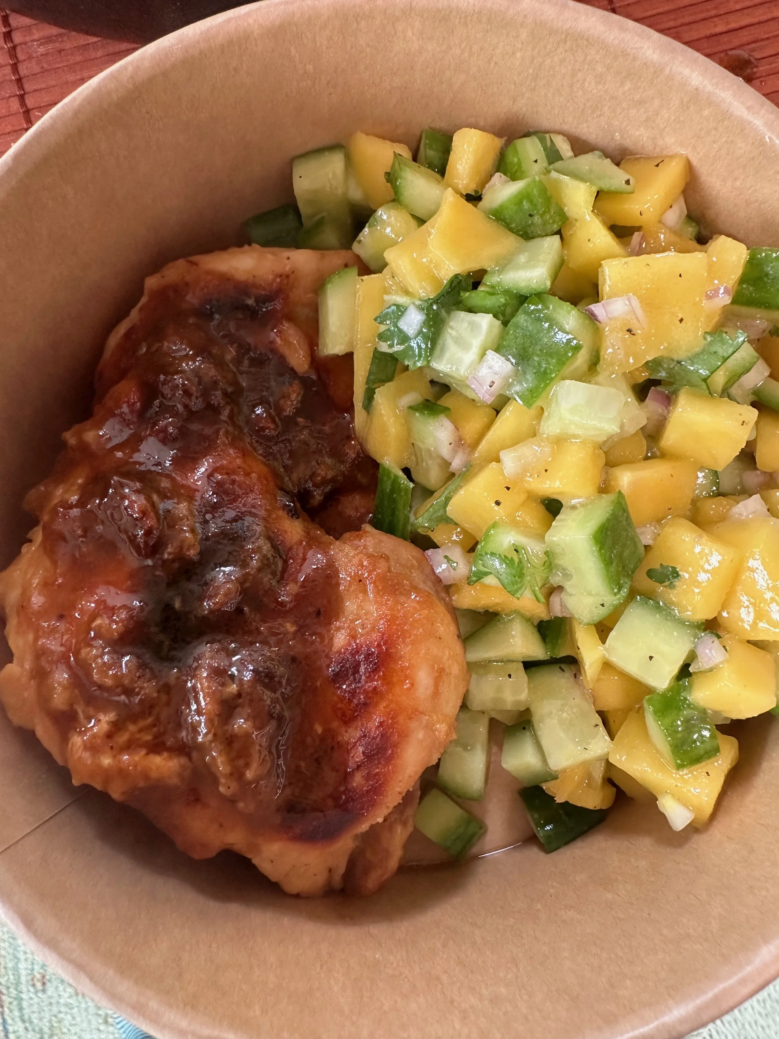Baked chicken thigh with brown gravy served with a cucumber and mango salad.