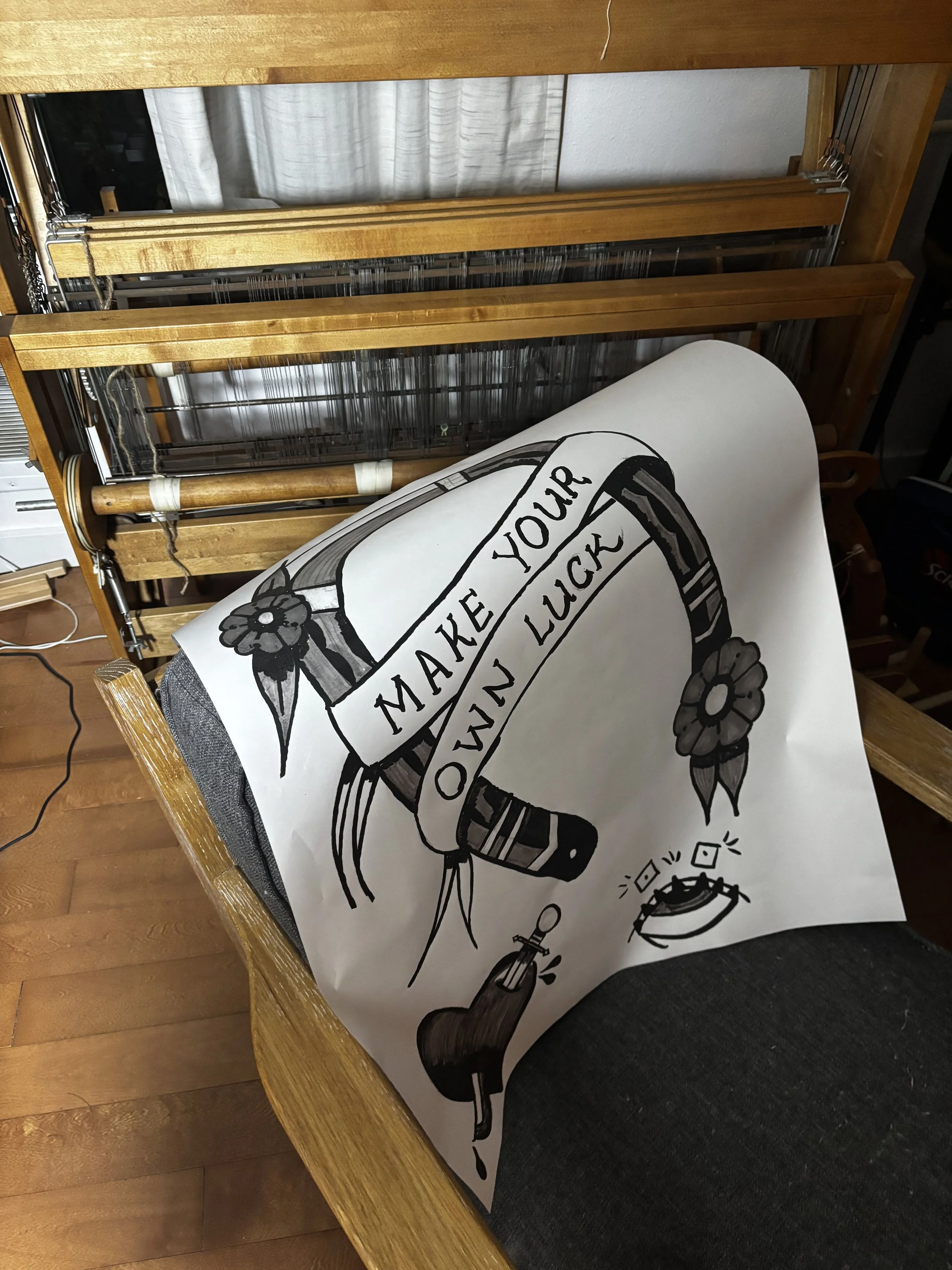 A paper drawing of a tapestry cartoon displaying a horseshow with a text banner that reads "make your own luck":