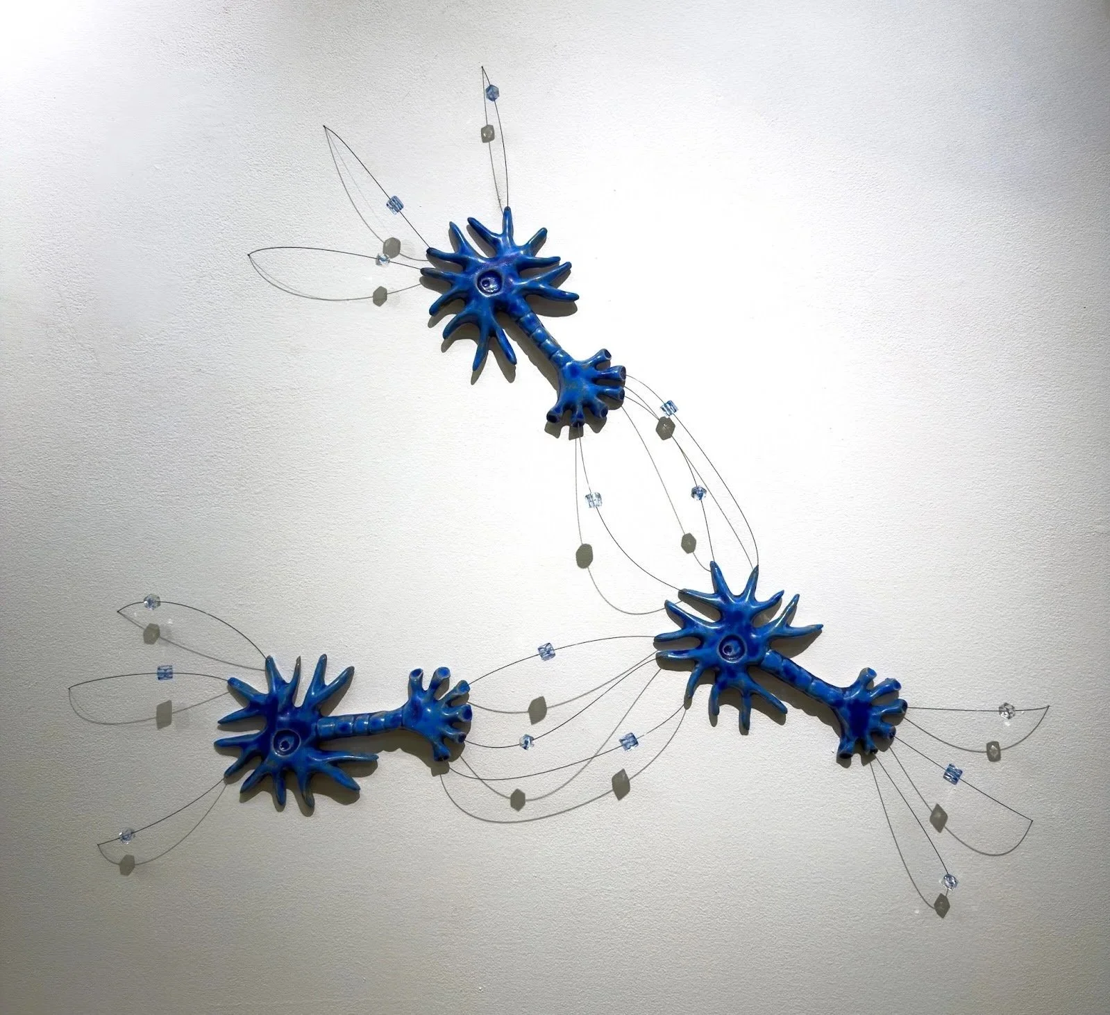 Axo-axonic, 2026
Ceramic, music wire, glass beads
H18”xW30”xD3”