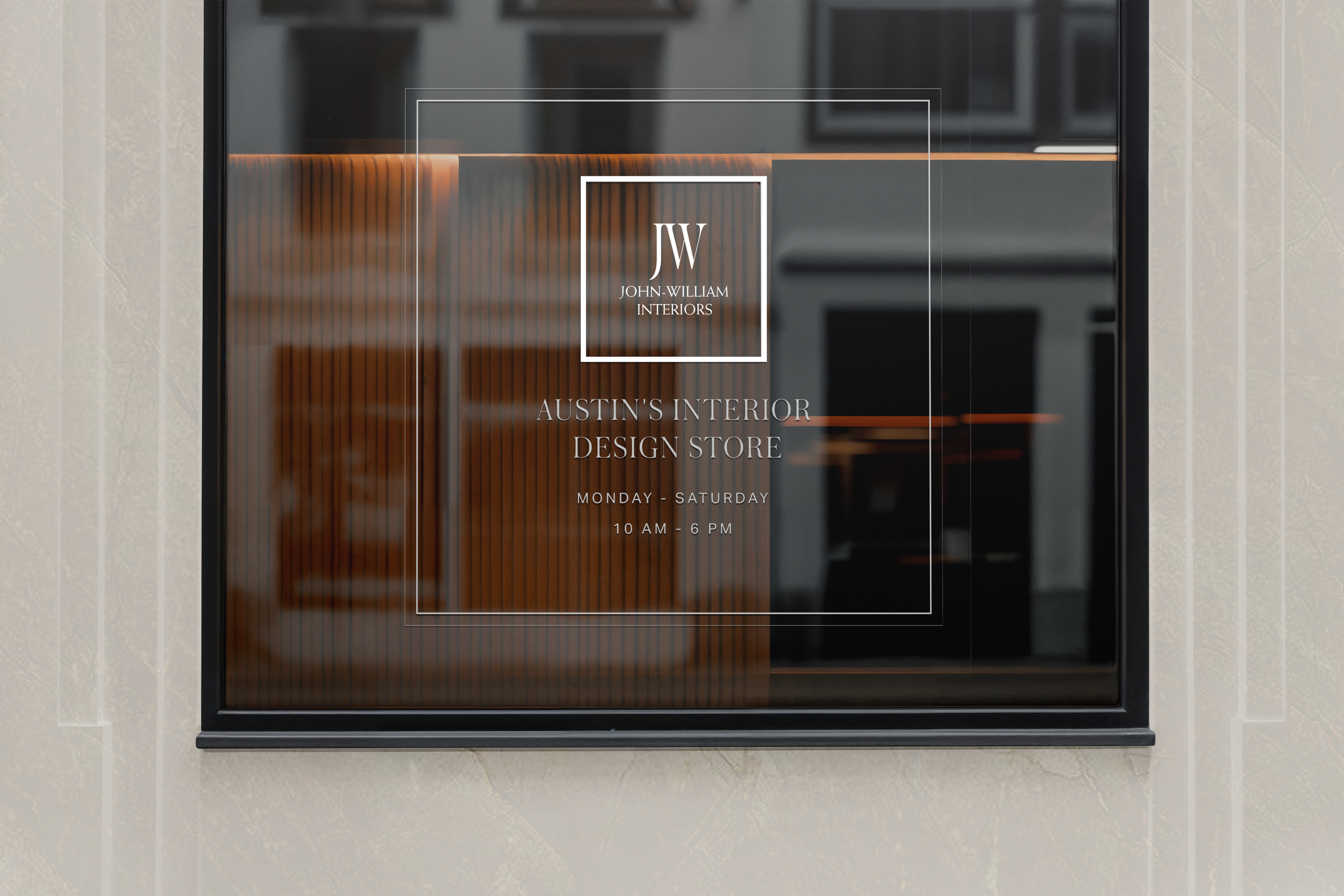 Glass door sign for John-William Interiors, Austin's Interior Design Store, open Monday through Saturday from 10 AM to 6 PM.