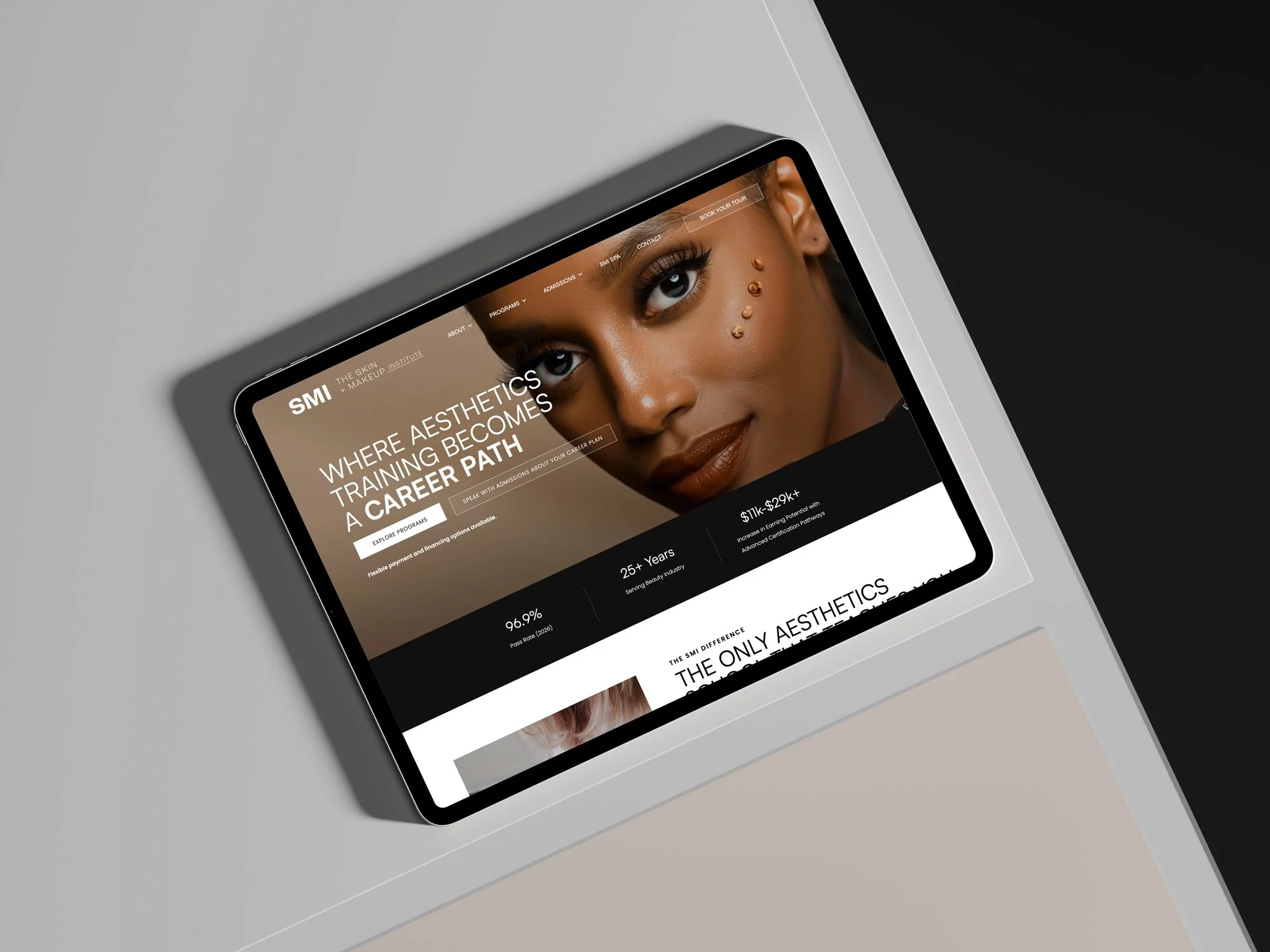 A tablet displaying a website for the Skin + Makeup Institute featuring a portrait of a woman with makeup and skincare decorations on her face.