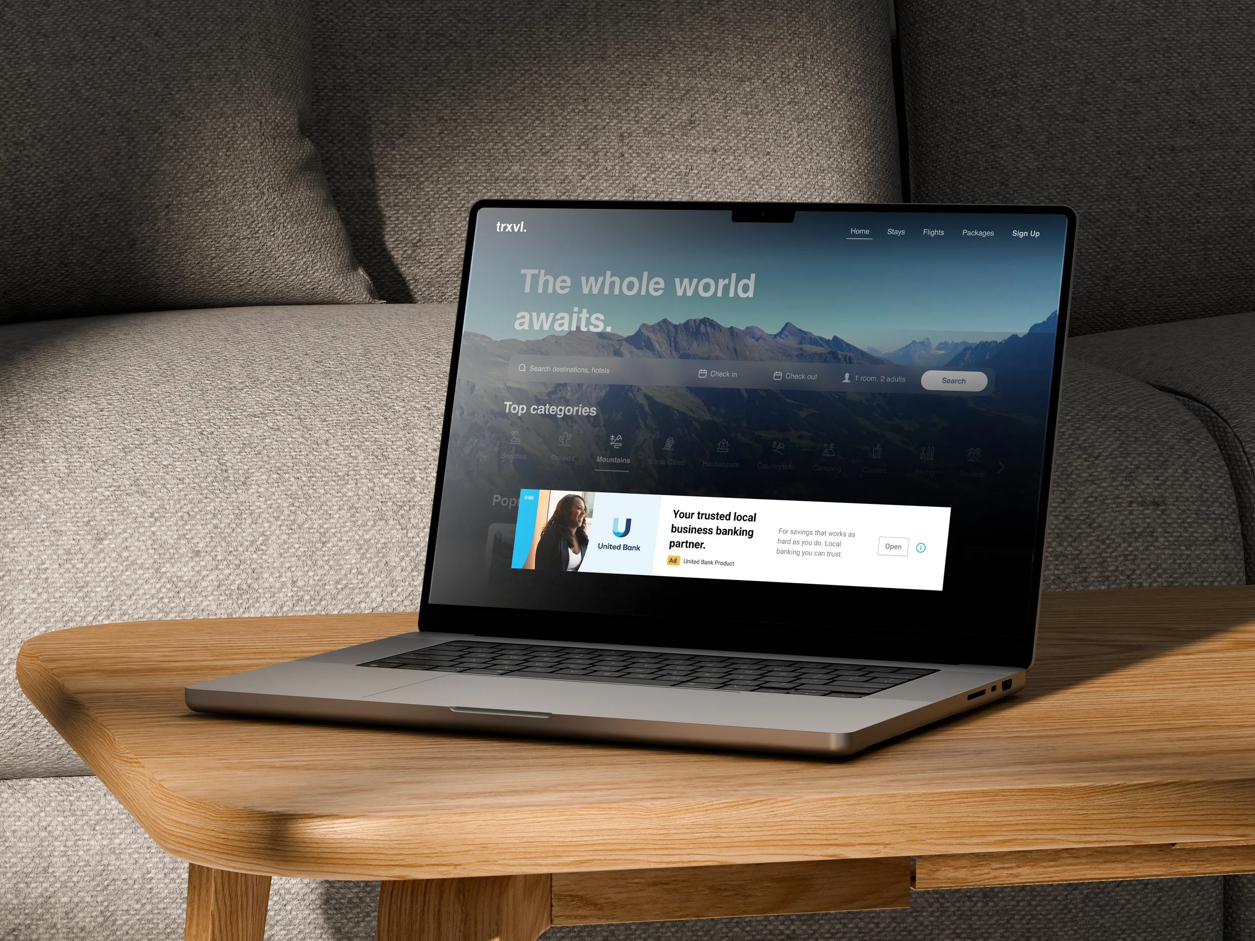 A desktop placed on a wooden table displaying a google ad on a website for United Bank of West Michigan with mountains in the background and navigation links at the top.