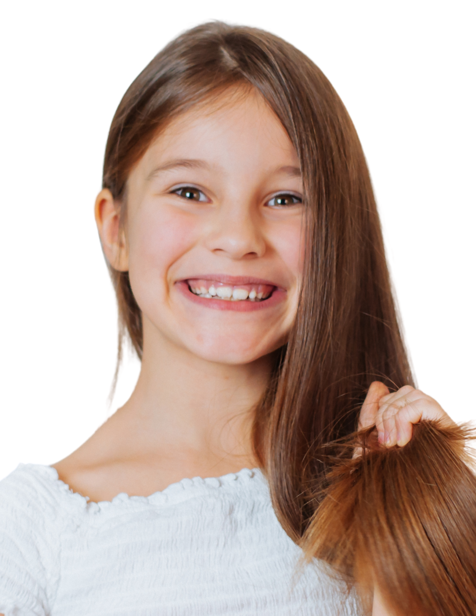 A girl with long red hair, smiling and holding a lock of her hair, wearing a white shirt.