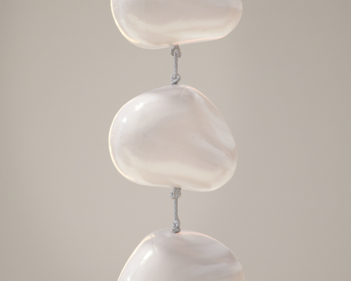 Close-up of a string of large white sea shells hanging from a string.