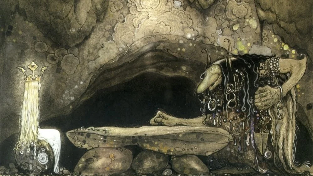 A mythical, troll-like creature with long, tangled hair and a large nose leaning over a stone table inside a cave, with a white cat-like creature with a crown and long flowing hair nearby.