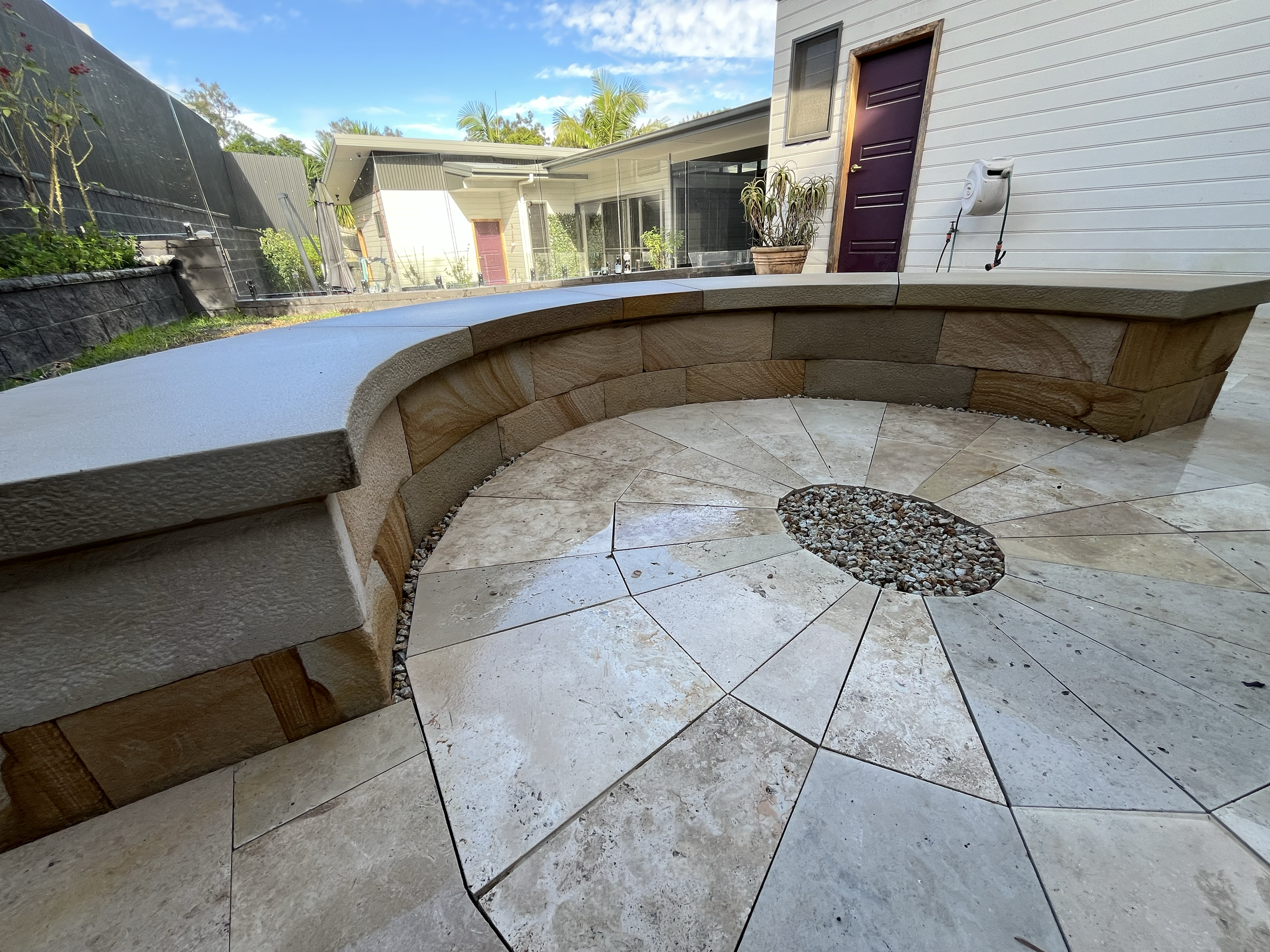 Curved sandstone bench and stone paving, Central Coast NSW