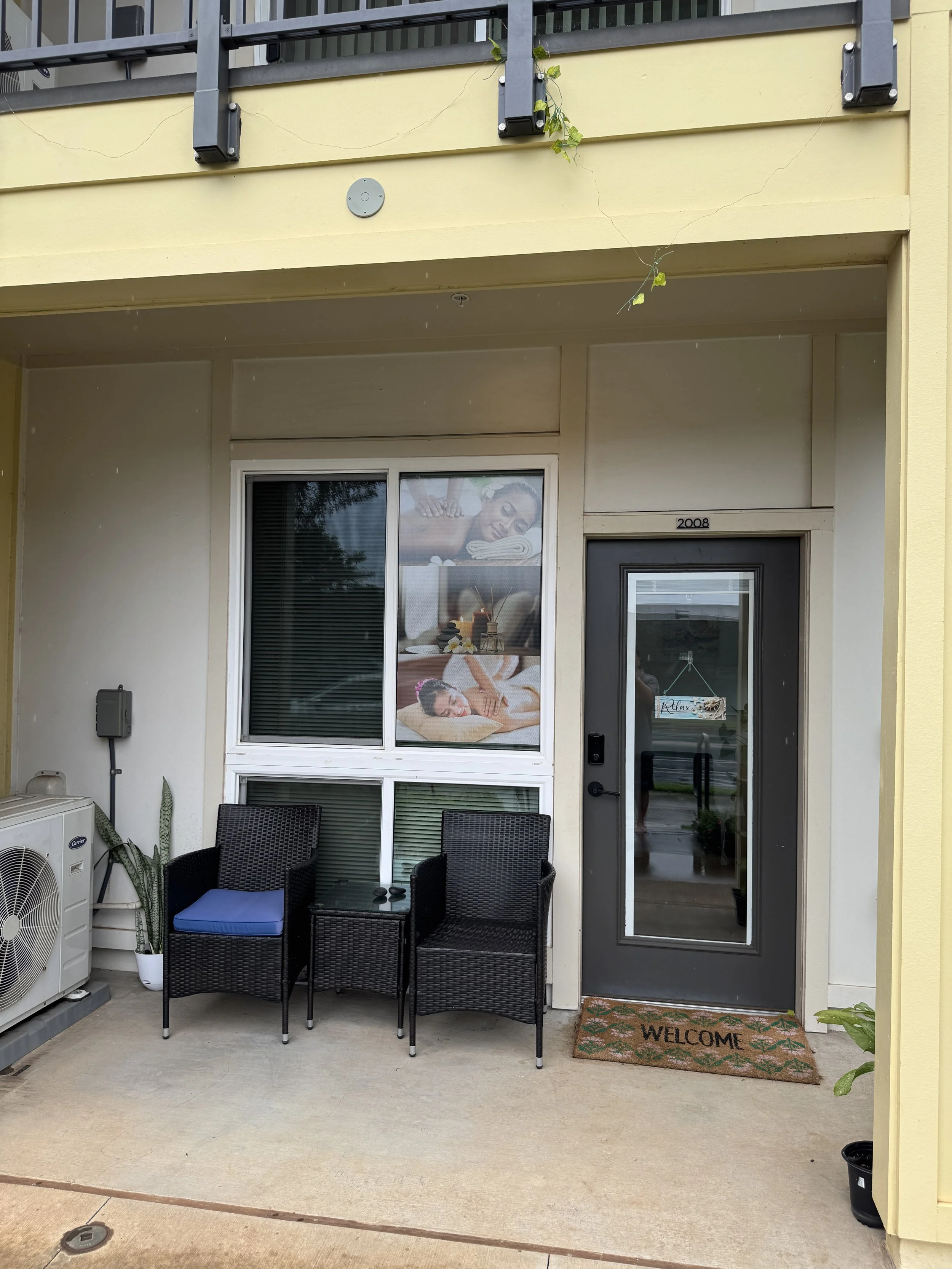 Thai Healing Massage entrance with massage poster to left of door in Ho'opili.