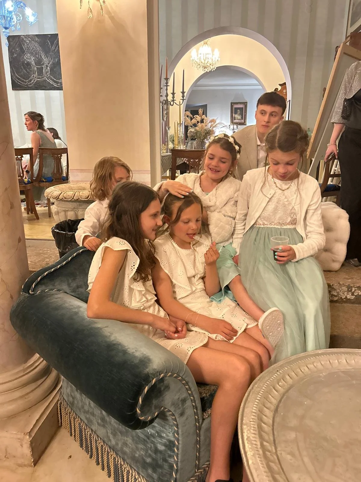 Children chilling at a wedding.