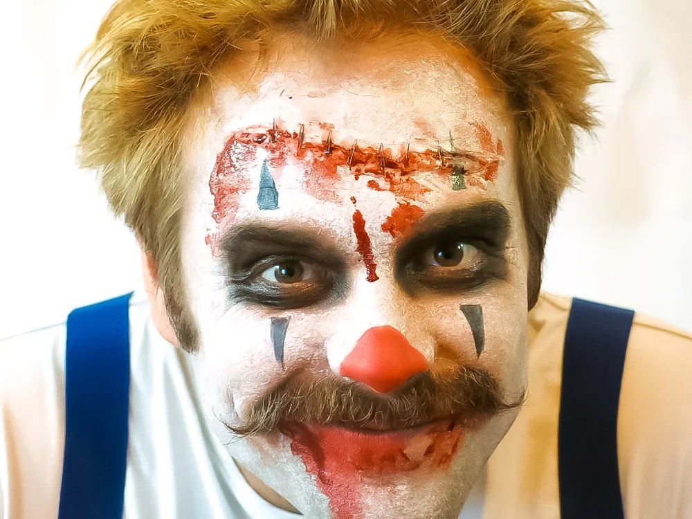 Special effects horror clown makeup with prosthetic wound detail by English-speaking SFX makeup artist, event in Ibiza