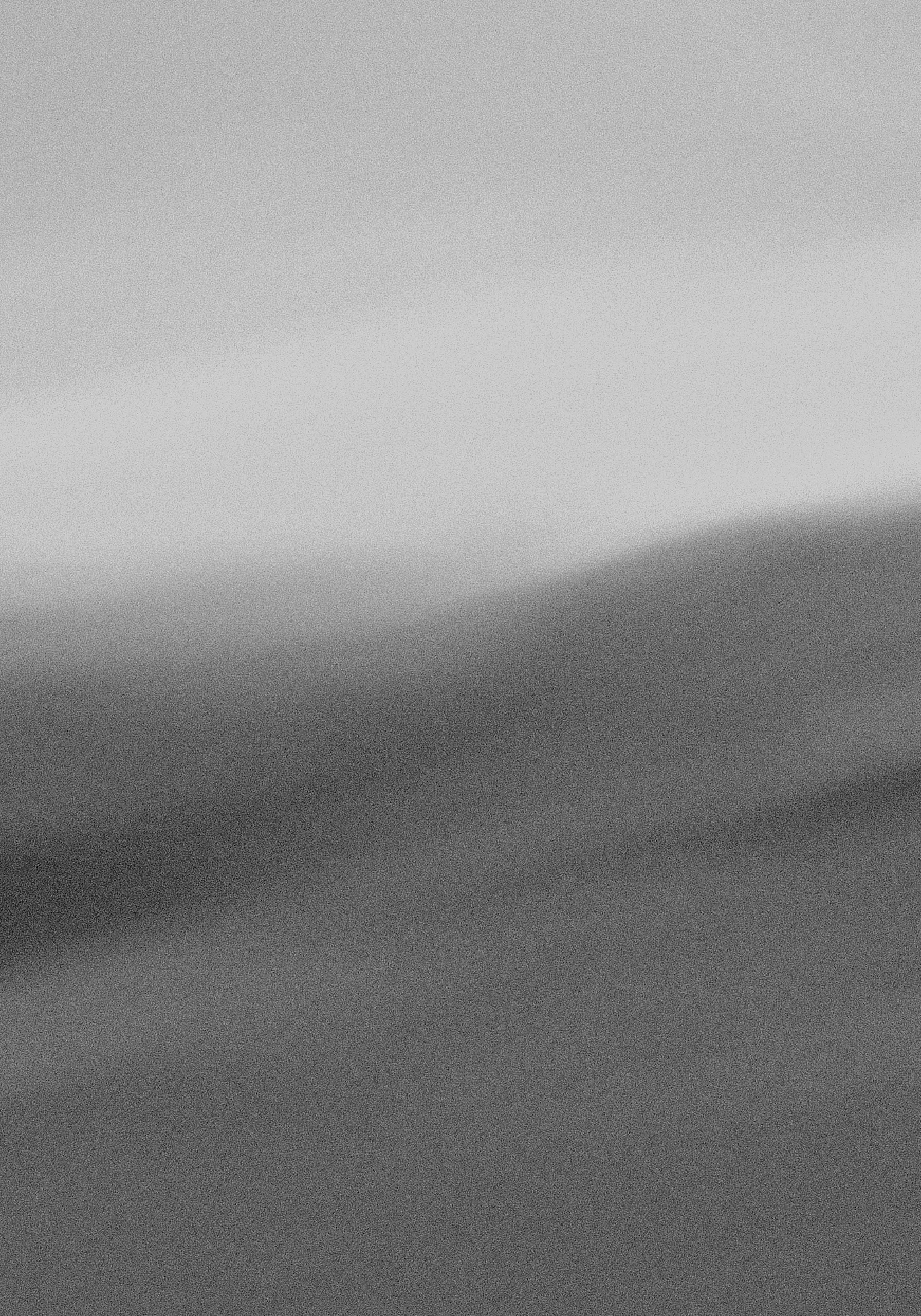A black and white abstract photo with shades of gray and blurred lines.
