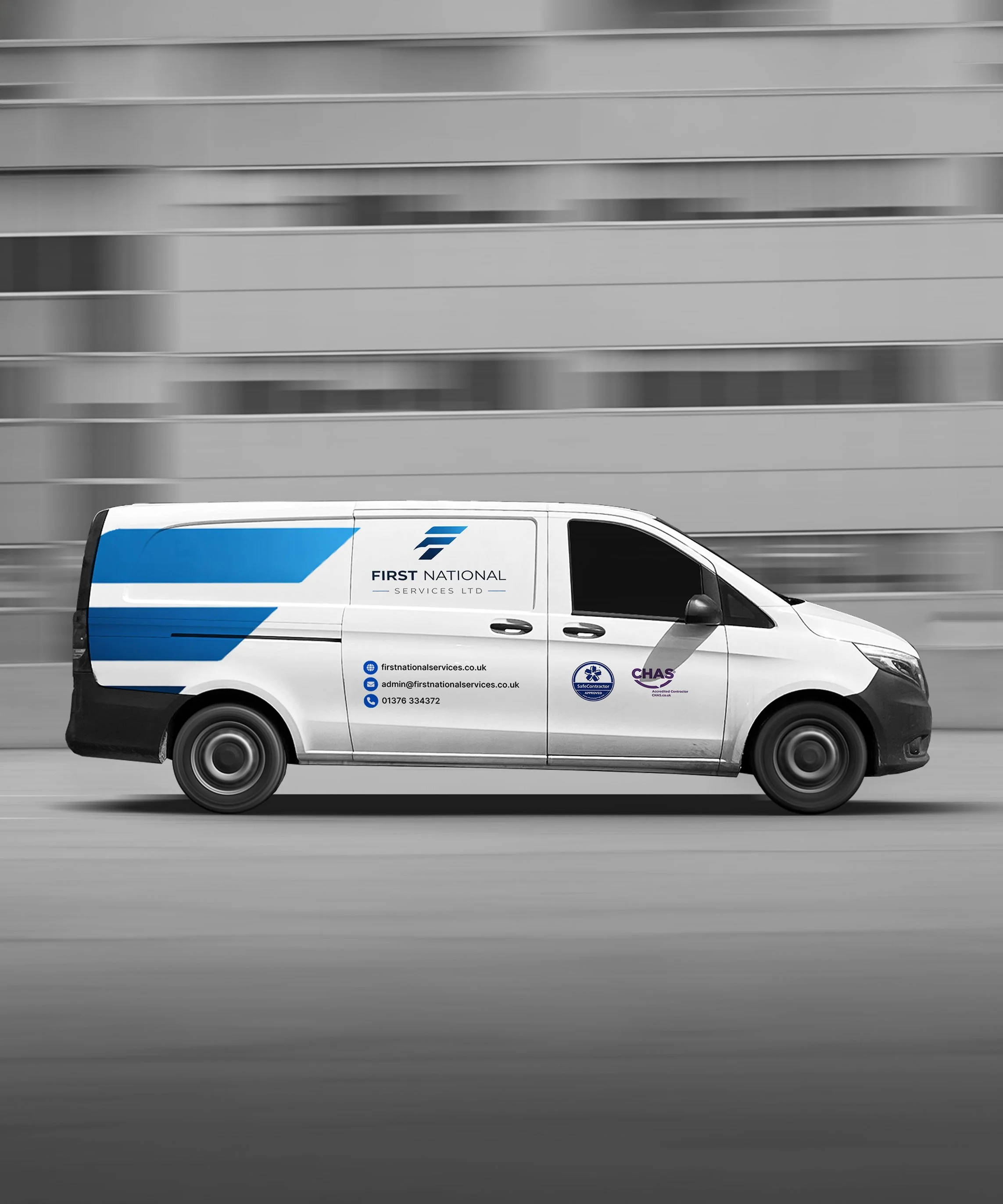 First National Services - White service van with blue and purple branding, driving past a blurred building background.
