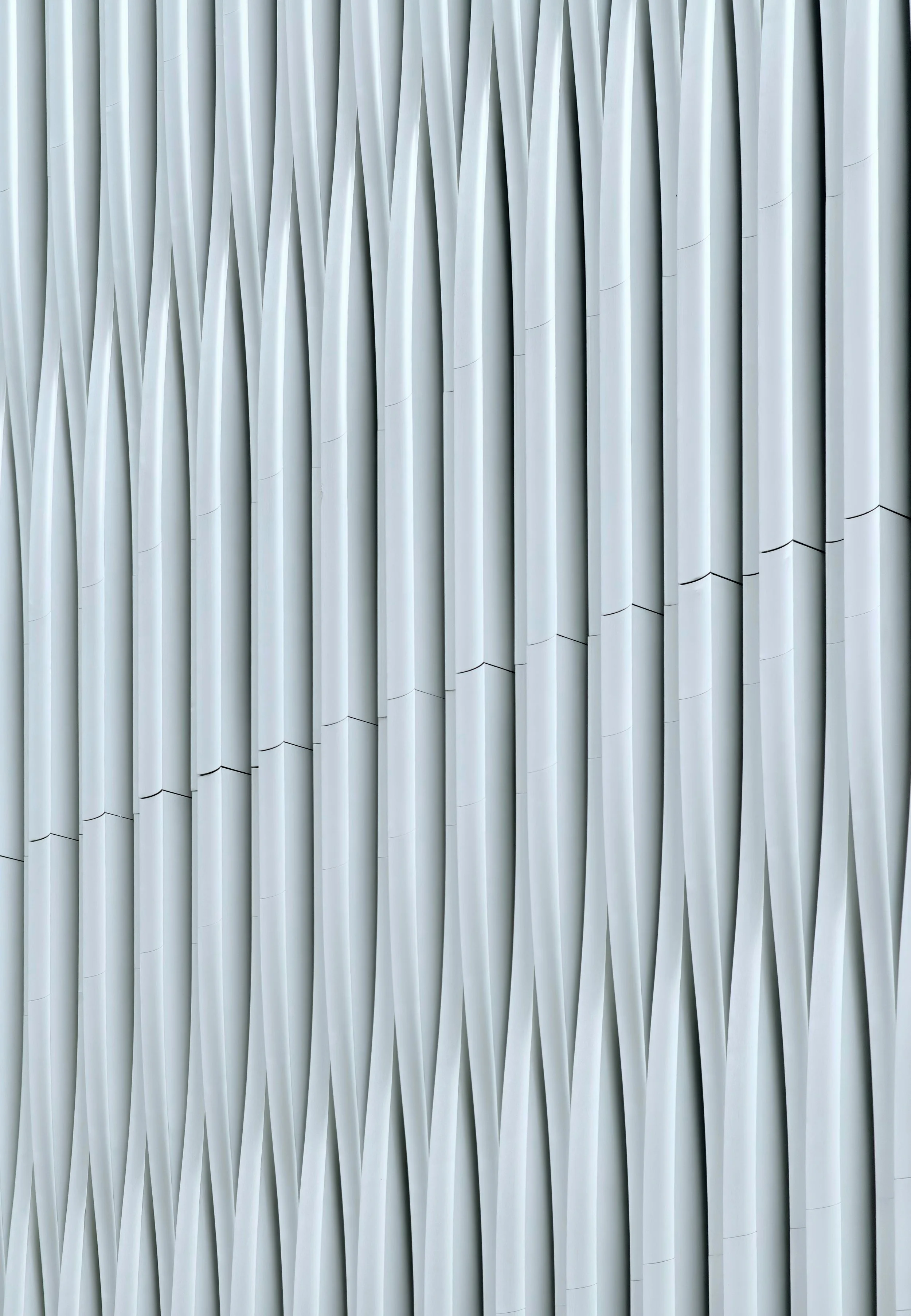 Close-up of a modern architectural facade with overlapping white vertical panels.
